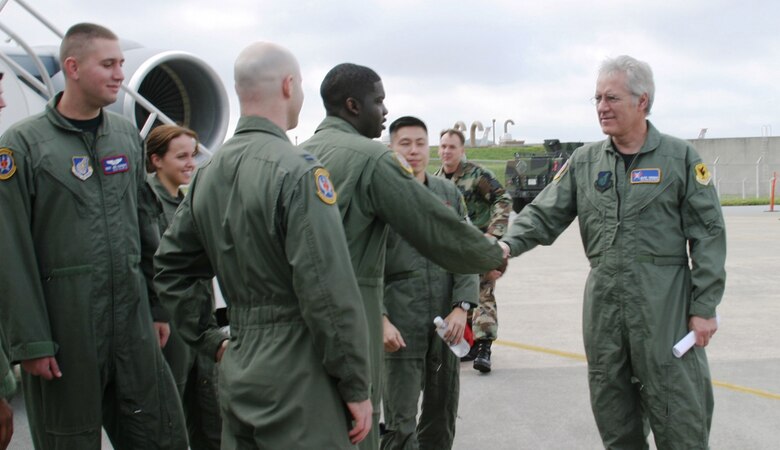 KADENA AIR BASE, Japan -- Alex Trebek, host of the Jeopardy game show, greets members of Kadena's 18th Aeromedical Evacuation Squadron and the 909th Air Refueling Squadron March 31 during a Jeopardy game show USO tour of Japan.  During a two-day trip to Kadena, Mr. Trebek and Jeopardy show staff also toured an F-22 stealth fighter, a KC-135 stratotanker, an E-3 AWACS (Airborne Warning and Control System), an F-15C fighter, and an HH-60 helicopter.  The F-22 is temporarily based at Kadena on its first overseas deployment from Langley Air Force Base, Va. Kadena residents were allowed to try-out to be contestants on Jeopardy, as well.  (Air Force/Senior Airman Nestor Cruz)
