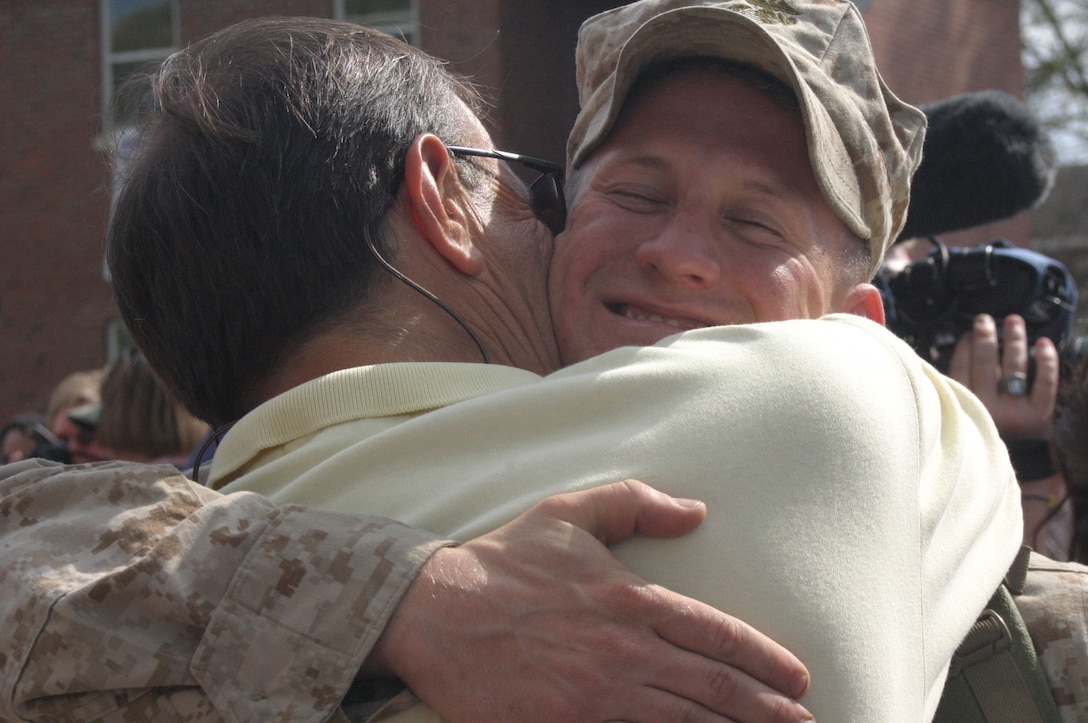 MARINE CORPS BASE CAMP LEJEUNE, N.C.- Lance Cpl. Michael Christiano, a Marine with 2nd Light Armored Reconnaissance Battalion, 2nd Marine Division, hugs his father after returning from a seven-month deployment to western Iraq. The battalion conducted counter-insurgency operations in the southwest region of the Al Anbar province of Iraq. This was their third deployment in support of Operation Iraqi Freedom. (Official U.S. Marine Corps photo by Cpl. Lucian Friel (RELEASED)