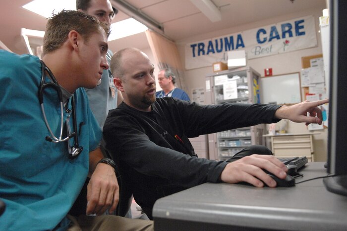 Senior Airman Charles Bezak (left), a pararescueman from the 58th Rescue Squadron reviews X-ray imagery with a University Medical Center emergency medical technician during hands on training along side the UMC medical staff March 30
(U.S Air Force Photo/Senior Airman Larry E. Reid Jr.)
