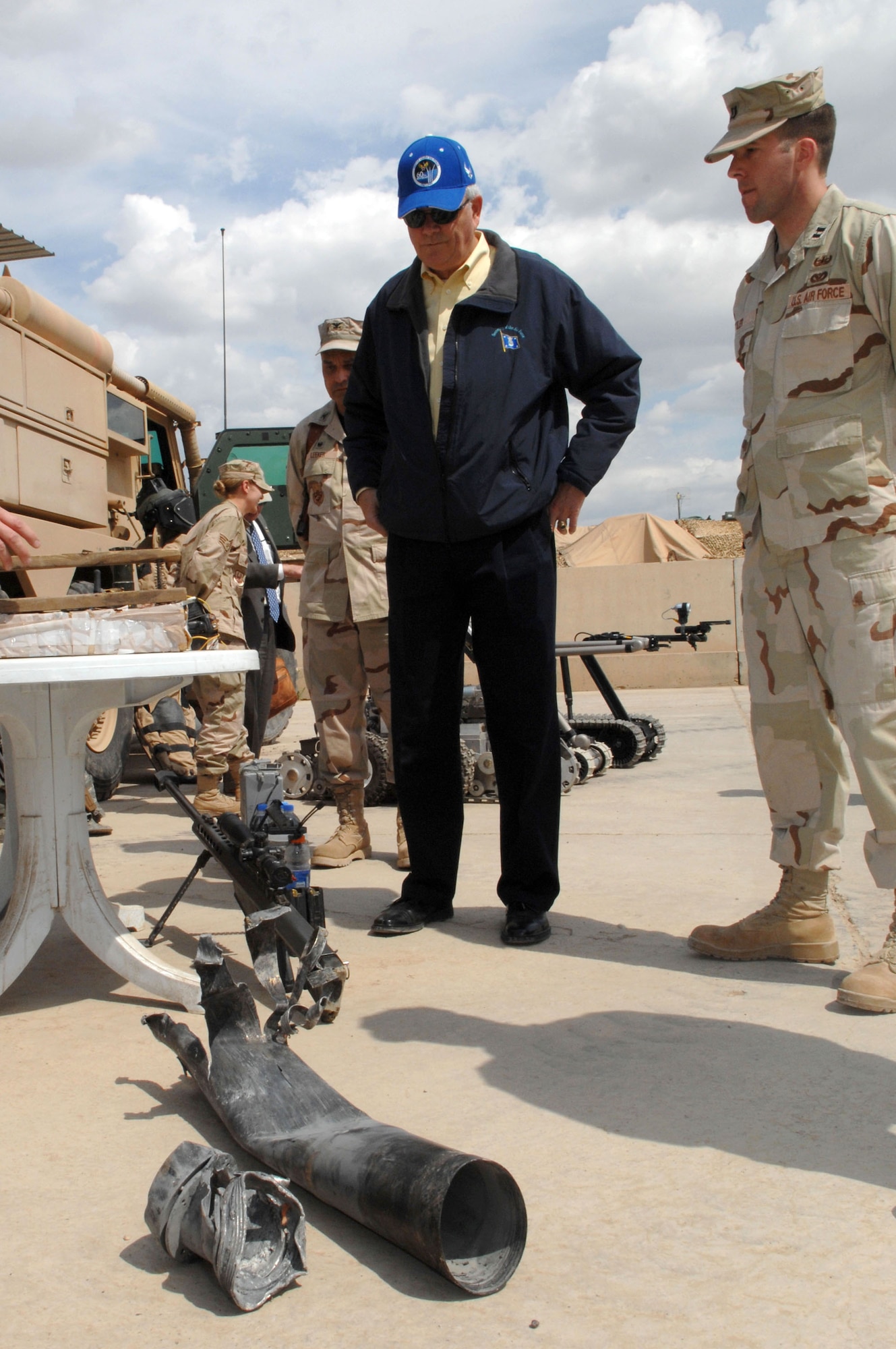 Capt. Joshua Tyler, the explosive ordnance disposal flight commander, shows Secretary of the Air Force, Michael W. Wynne, a rocket that was used by insurgents in the city of Kirkuk just two days prior to the secretary's visit March 28 at Kirkuk Air Base in Iraq. (U.S. Air Force photo/Senior Airman Bradley A. Lail) 