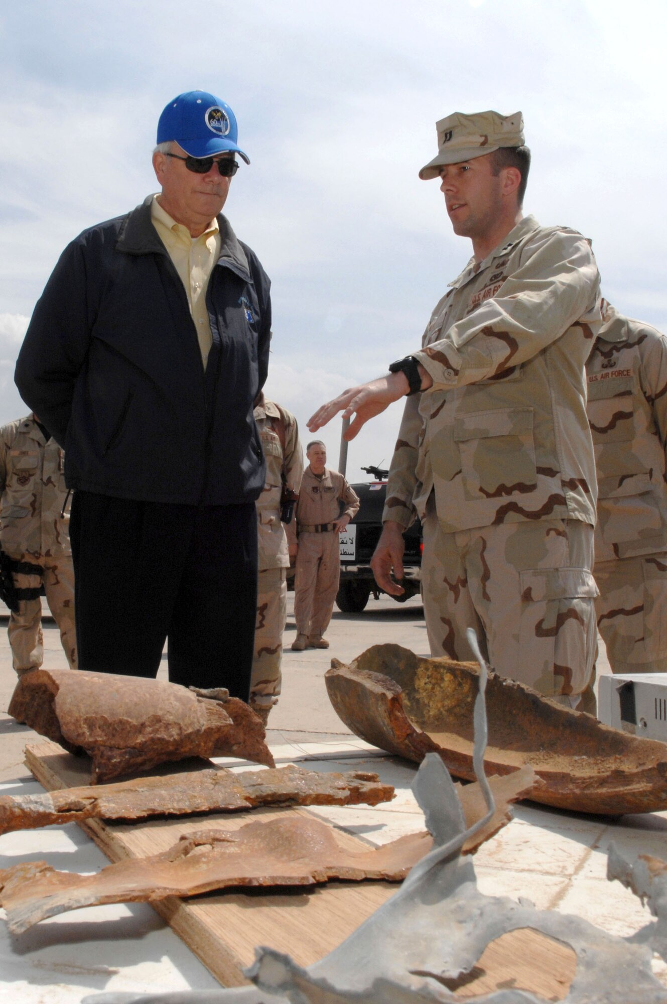 Capt. Joshua Tyler, the explosive ordnance disposal flight commander, explains to the Secretary of the Air Force, Michael W. Wynne, March 28, the different types of unexploded ordnances and improvised explosive devices that they encounter on a regular basis at Kirkuk Air Base in Iraq. (U.S. Air Force photo/Senior Airman Bradley A. Lail) 