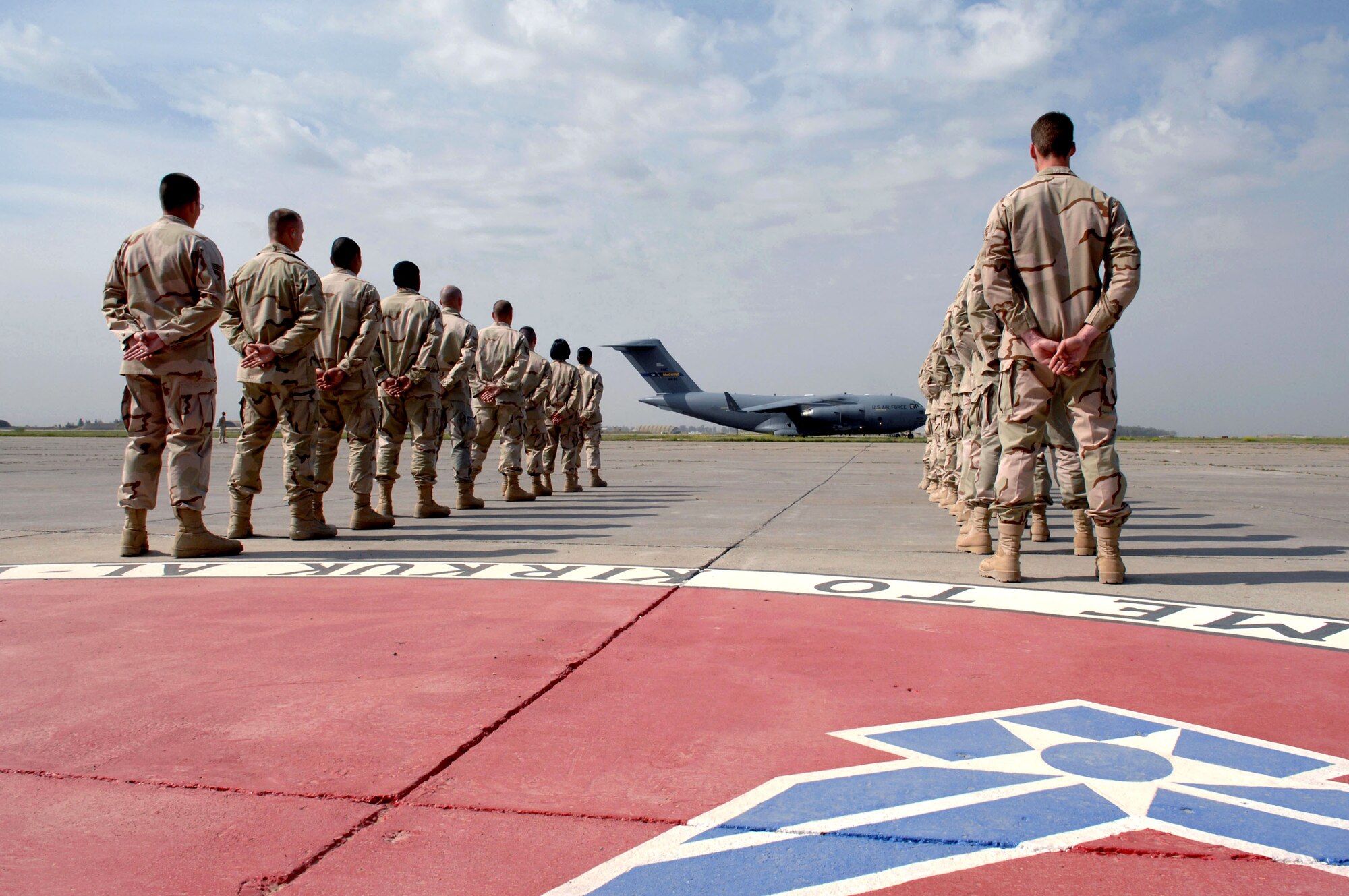 Secretary of the Air Force Michael W. Wynne arrives on a C-17 Globemaster III as Airmen of the 506th Air Expeditionary Group await his arrival March 28 at Kirkuk Air Base, Iraq. (U.S. Air Force photo/Senior Airman Bradley A. Lail) 
