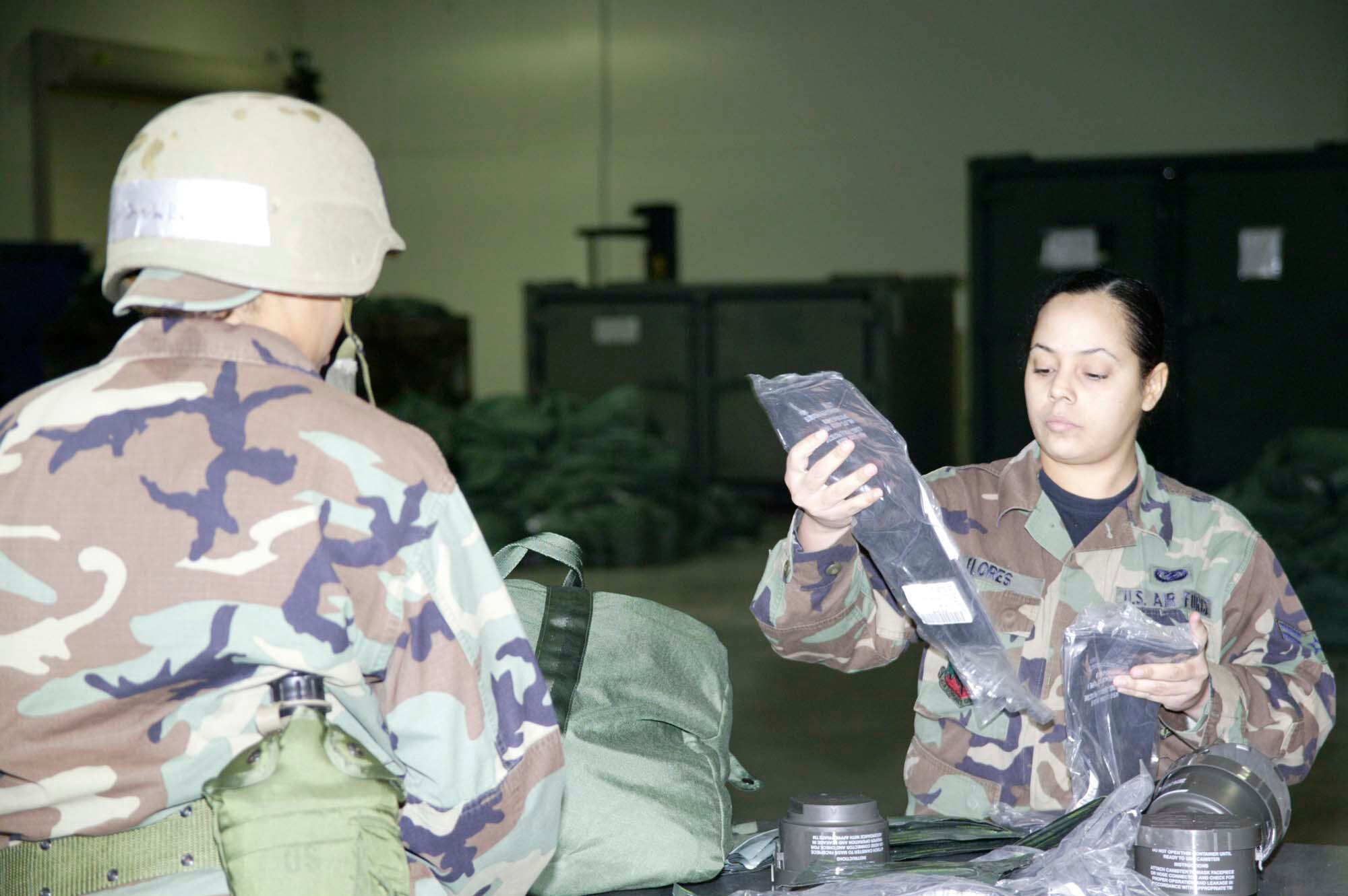 SHAW AIR FORCE BASE, S.C. -- Airman 1st Class Ondina Flores, 20th Communications Squadron distribution clerk, checks chemical warfare gear for accountability and serviceability March 27 at the exercise deployment line in the new Chandler Deployment Processing Center. (U.S. Air Force photo/Senior Airman Holly MacDonald)