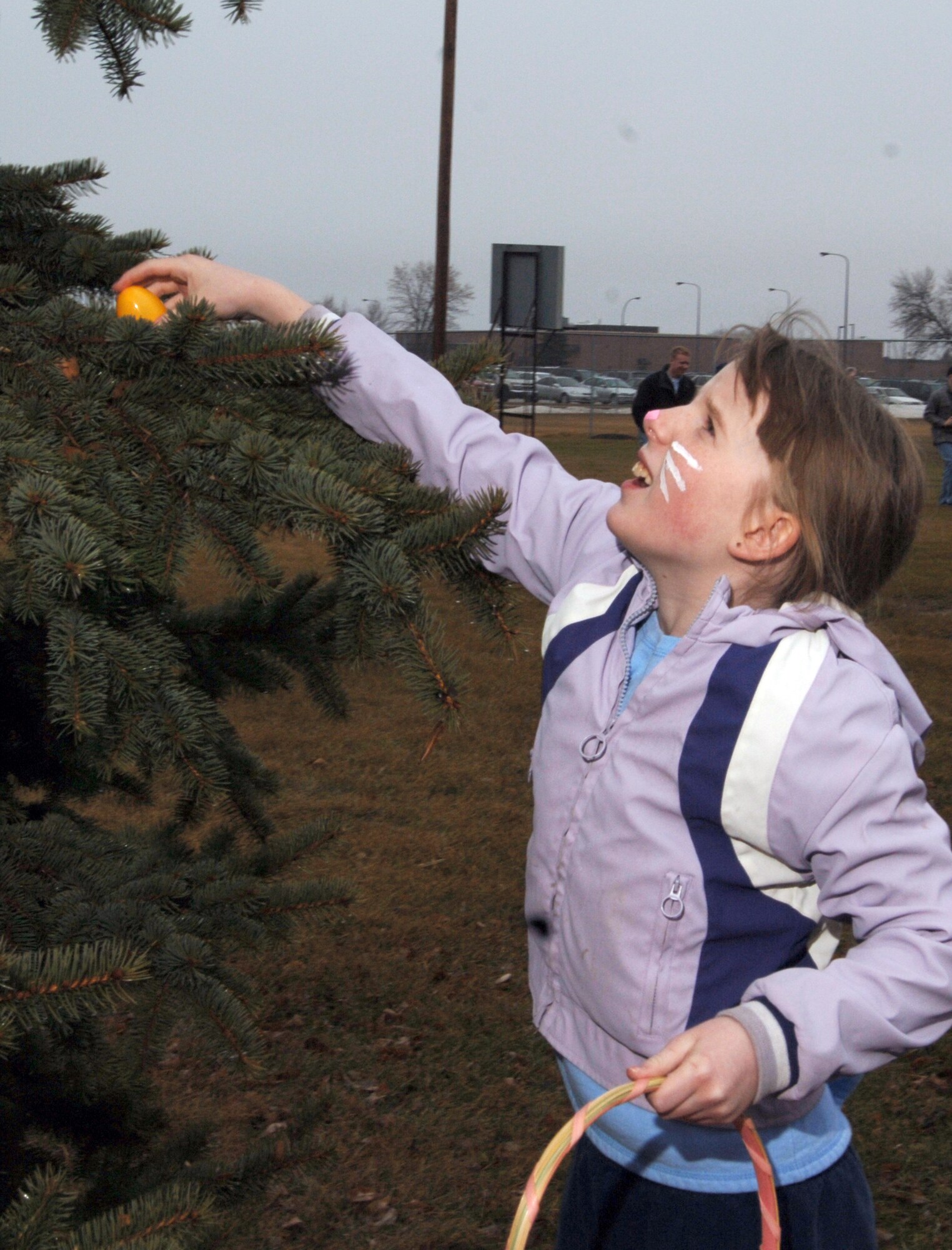 GRAND FORKS Air Force Base, N.D.-- Shanna Nuckolls, daughter of Staff Sgt. Suellyn Nuckolls, 319th Communication Squadron, searches for Easter eggs during an egg hunt here March 31.  (US Air Force photo/Staff Sgt. Suellyn Nuckolls)

