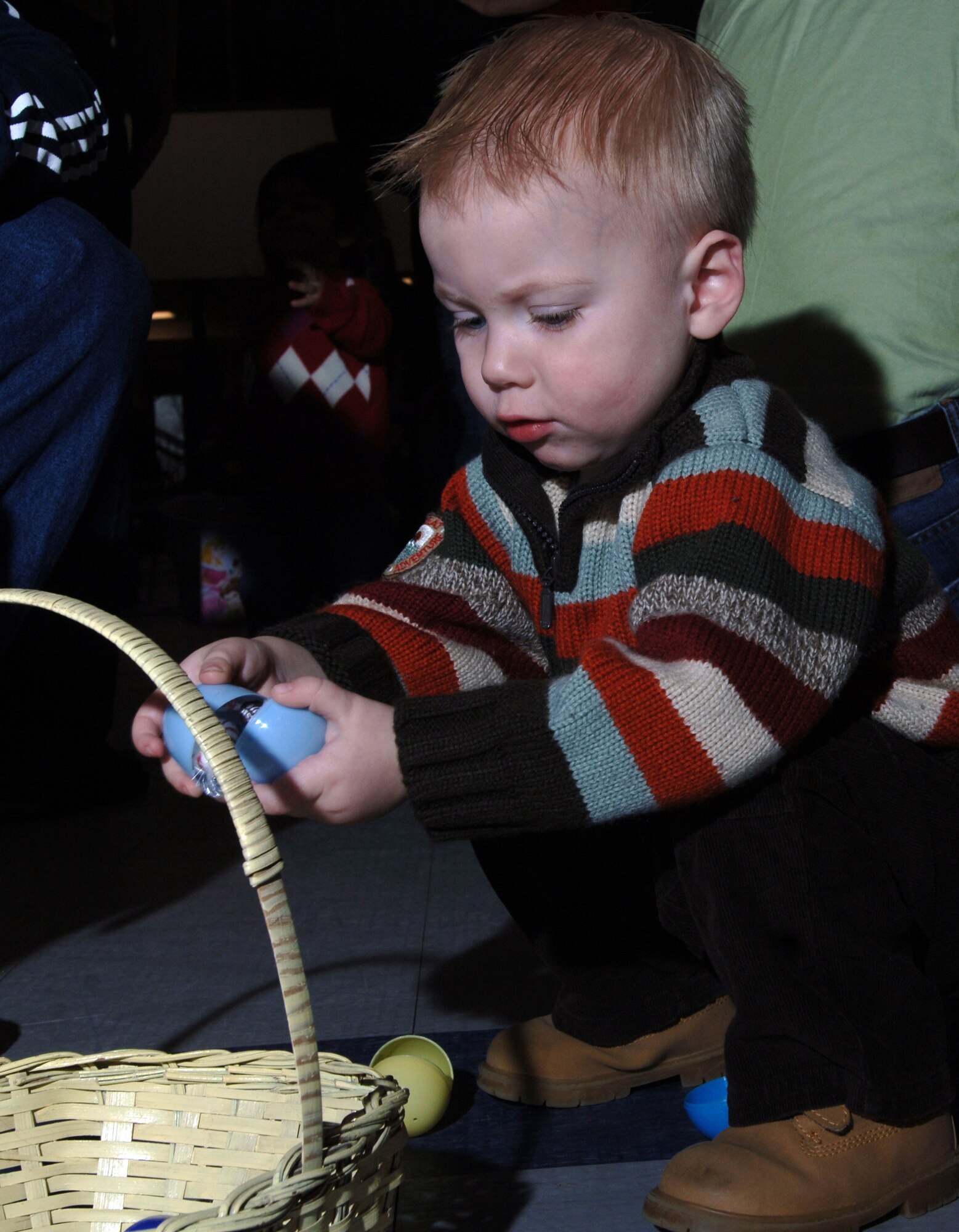 GRAND FORKS AFB, ND-- Logan Cappon, son of Staff Sgt. Jarod Cappon, 319th Security Forces Squadron, reaps the rewards of his Easter egg hunt.  The wing celebrated Easter with various events such as an egg toss, egg hunt, pictures with the Easter bunny and refreshments.  The event was held at Liberty Square March 31. (US Air Force photo/Staff Sgt Suellyn Nuckolls)