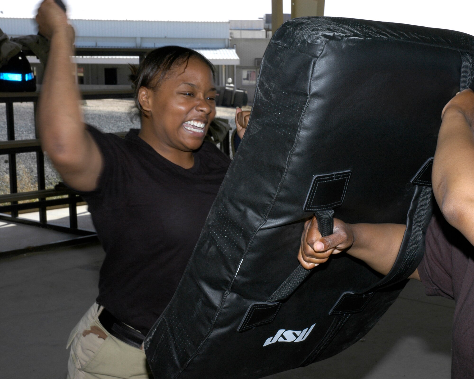 SOUTHWEST ASIA -- Airman 1st Class Deloric Harrison, assigned to the 386th Expeditionary Security Forces Squadron received ASP training on March 30, 2007.  A1C Harrison practiced an open mode weapon side strike to the body's "collar bone" area.  The personal defense course taught personnel assigned to Security Forces Squadron how to use a less than lethal weapon to defend themselves.  65 personnel assigned to the Security Forces Squadron received the training.  (AF photo/ Staff Sgt. Ian Carrier)                                