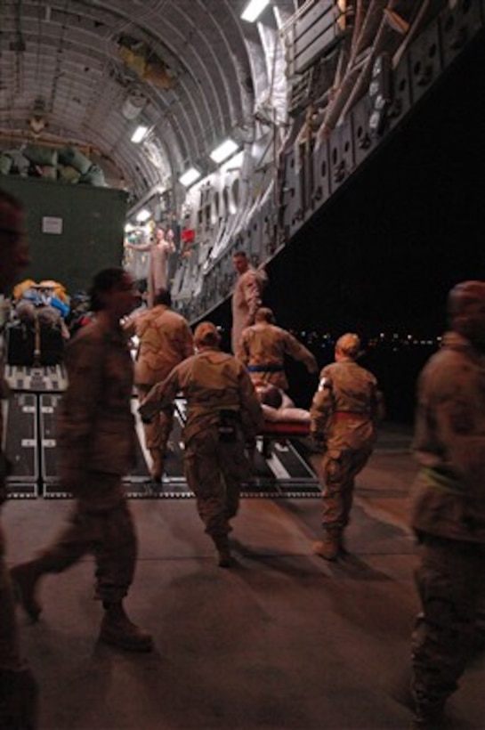 Medical personnel carry a patient on a stretcher into a U.S. Air Force C-17 Globemaster III at Ramstein Air Base, Germany, for a medical evacuation flight to Andrews Air Force Base, Md., on March 4, 2007.  The Globemaster is attached to the 172nd Airlift Wing, Mississippi Air National Guard.  