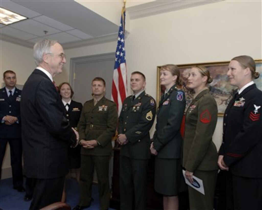 Deputy Secretary of Defense Gordon England (right) meets with "Why We Serve" military speakers in the Pentagon prior to their 90-day-tour on March 30, 2007. The eight service members have been previously deployed to Iraq, Afghanistan or the Horn of Africa and will tell the military's story to the American public.  