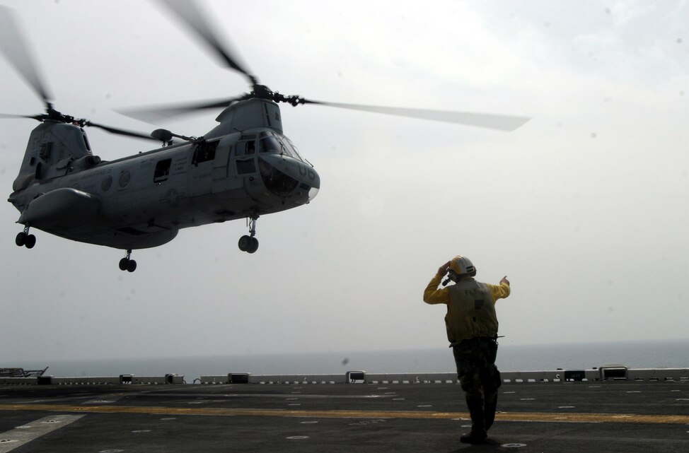 A Sailor from USS Bataan guides a CH-46E Sea Knight helicopter from Marine Medium Helicopter Squadron-264 (Reinforced), 26th Marine Expeditionary Unit, off the flight deck of USS Bataan, April 3, 2007.  The helicopter was loaded with Marines and Sailors from Company E, Battalion Landing Team 2/2, 26th MEU, preparing to conduct helicopter rope suspension training.  (Official USMC photo by Cpl. Jeremy Ross) (Released)