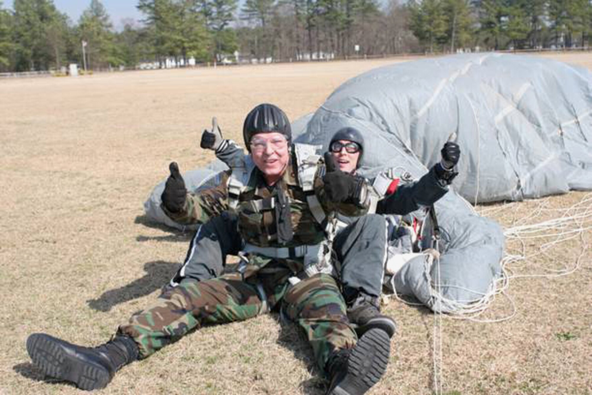 Chief Master Sgt. of the Air Force Rodney J. McKinley indicates a safe landing after a tandem parachute jump with a member of the 24th Special Tactics Squadron from Pope Air Force Base, N.C.   The rare opportunity to jump with special tactics Airmen took place when Chief McKinley was accompanying Chief Master Sgt. Michael Gilbert, command chief of Air Force Special Operations Command, on a recent tour of AFSOC units.  Special tactics Airmen - combat controllers, pararescuemen and special operations weathermen ? work with Special Operators from all services on missions deep in enemy territory.  Their expertise includes conducting personnel recovery missions, collecting intelligence and providing terminal guidance for air attacks against valuable enemy targets.  They also generate high fidelity, localized, mission tailored weather forecasts for the ingress, employment, and egress of air, land and sea forces.  (Courtesy photo)