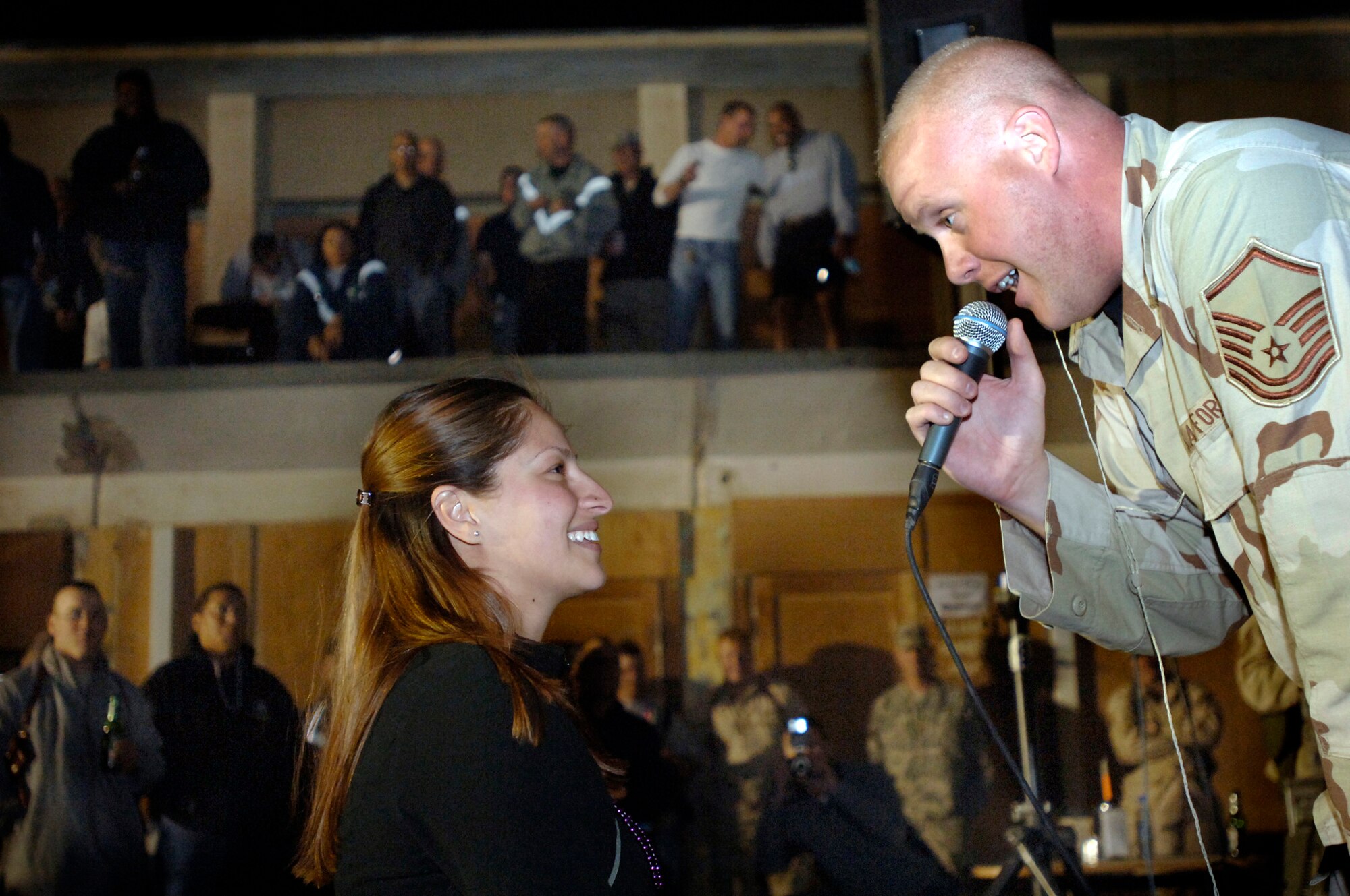 Master Sgt. Ryan Carson sings to Senior Airman Christina Bueno at Camp Alamo in the Kabul Military Training Center at Afghanistan. Approximately 200 U.S. servicemembers and coalition forces were treated to the sounds of Max Impact. Sergeant Carson is a lead vocalist with the U.S. Air Force Band ensemble from Bolling Air Force Base, D.C. (U.S. Air Force photo/Tech. Sgt. Cecilio M. Ricardo Jr.)