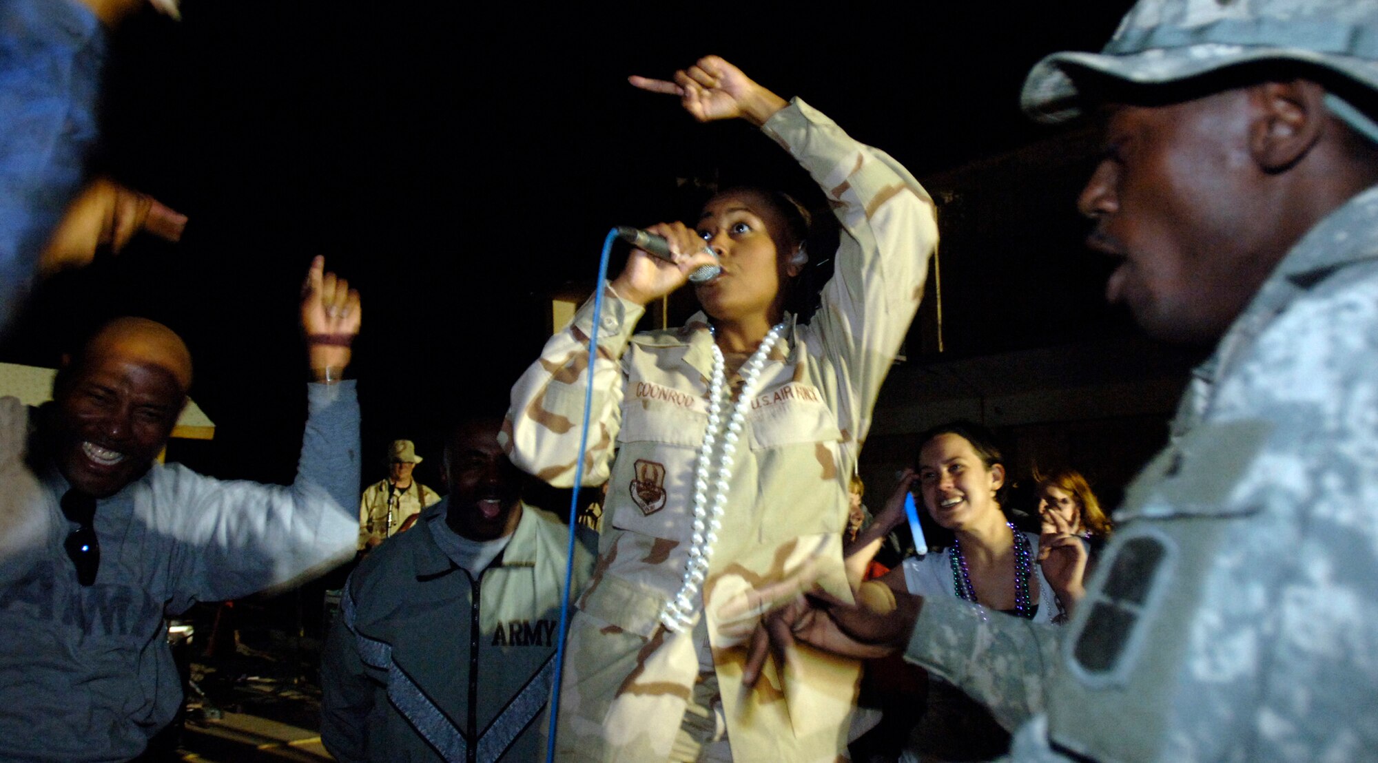 Master Sgt. Regina Coonrod sings at Camp Alamo in the Kabul Military Training Center in Afghanistan. Approximately 200 U.S. servicemembers and coalition forces were treated to the sounds of Max Impact. Sergeant Coonrod is a lead vocalist with the U.S. Air Force Band ensemble from Bolling Air Force Base, D.C. (U.S. Air Force photo/Tech. Sgt. Cecilio M. Ricardo Jr.)
