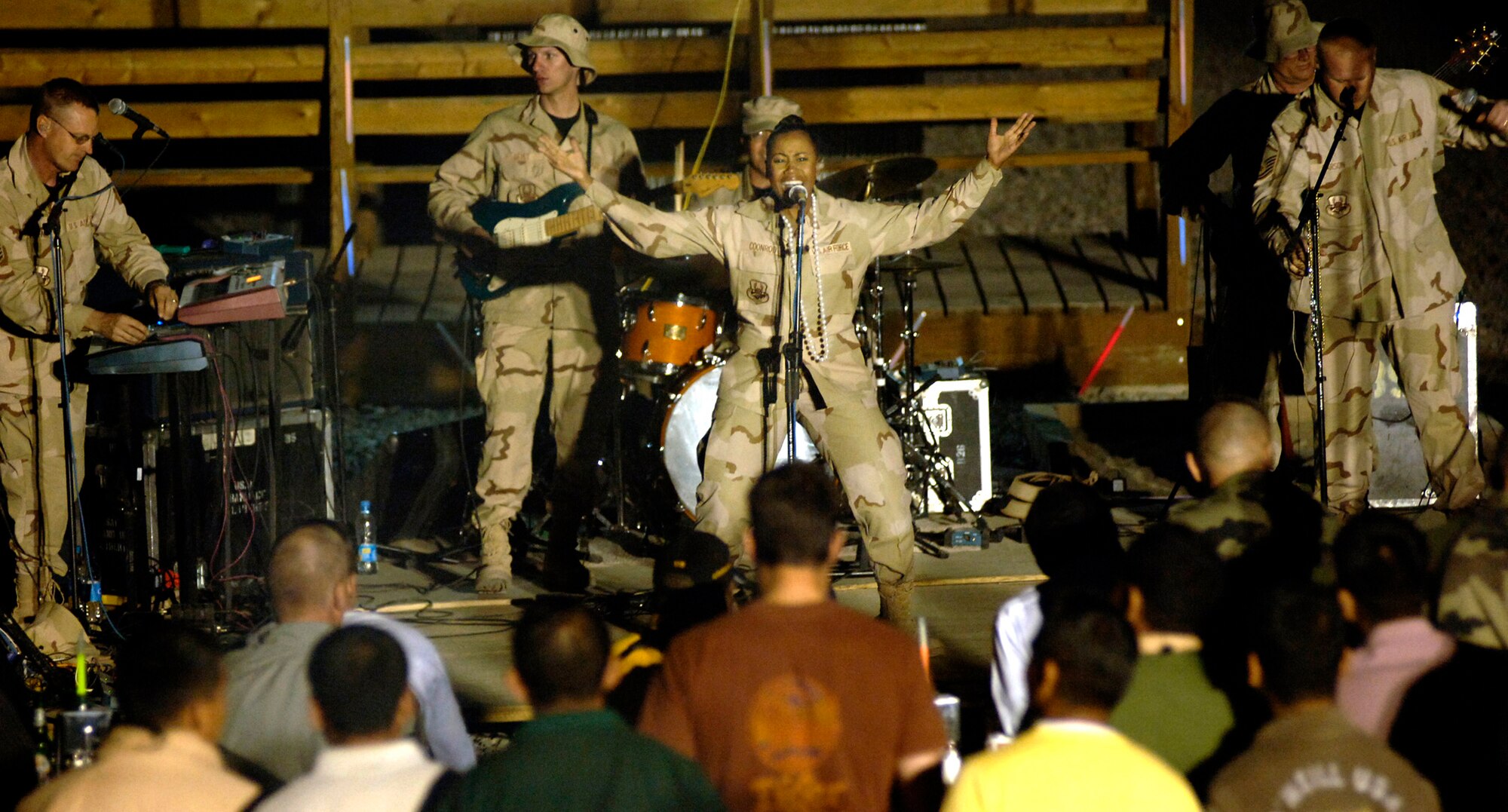 Master Sgt. Regina Coonrod sings at Camp Alamo in the Kabul Military Training Center in Afghanistan. Approximately 200 U.S. servicemembers and coalition forces were treated to the sounds of Max Impact. Sergeant Coonrod is a lead vocalist with the U.S. Air Force Band ensemble from Bolling Air Force Base, D.C. (U.S. Air Force photo/Tech. Sgt. Cecilio M. Ricardo Jr.)