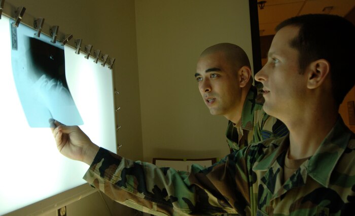 Staff Sgt. Christopher Harris and Staff Sgt. Kevin Kelley, 437th Medical Group diagnostic imaging journeymen, review the X-ray of a patient's broken left shoulder  March 30, 2007 at the Charleston AFB clinic. (U.S. Air Force photo/Staff Sgt. April Quintanilla)