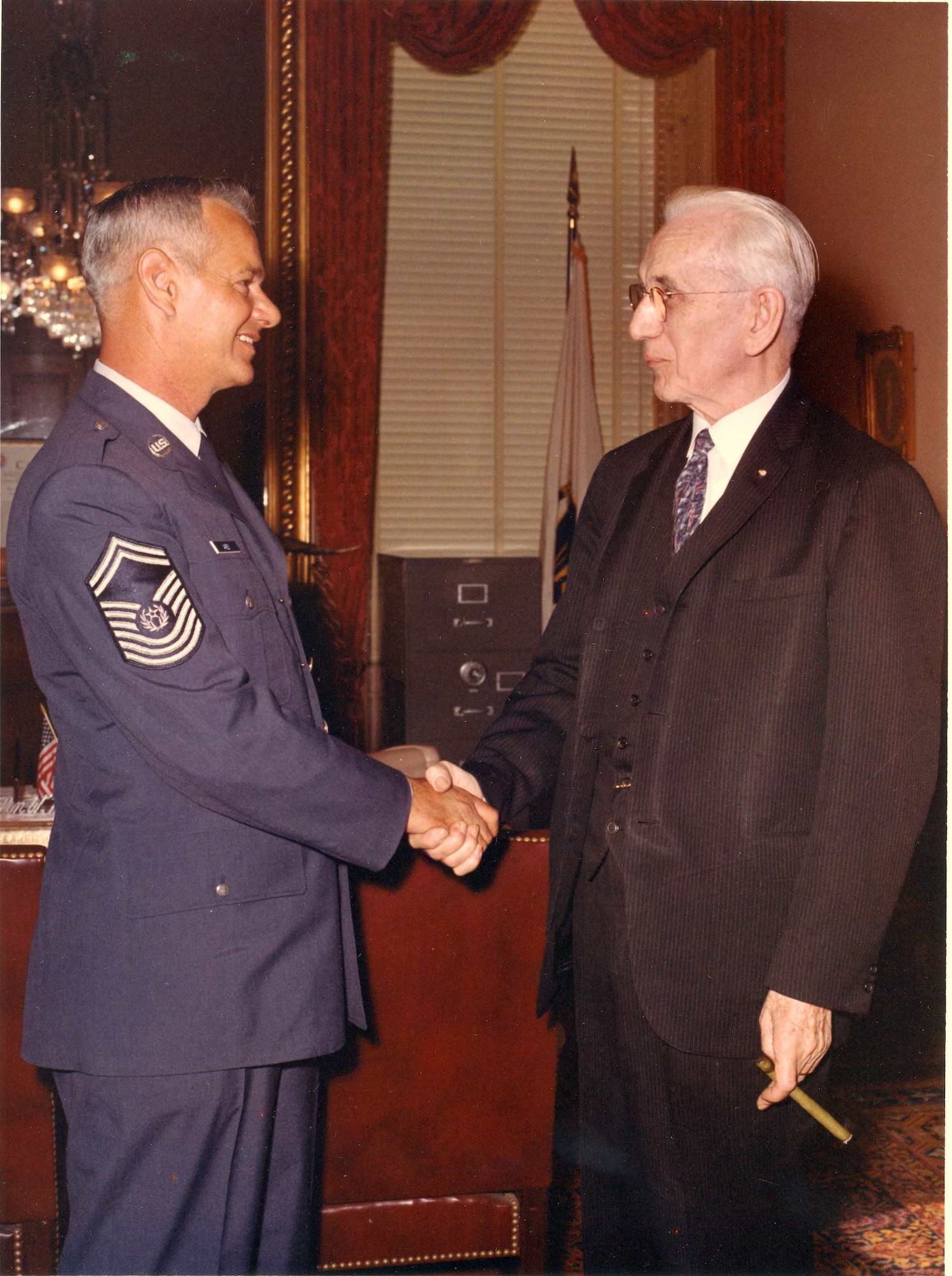 Chief Master Sgt. Paul Airey, being congratulated by Massachusetts Congressman John W. McCormack, was selected as the first chief master sergeant of the Air Force on April 3, 1967.  During his tenure he visited many bases and talked with many Airmen about improving conditions for the enlisted force.  (U.S. Air Force file photo)