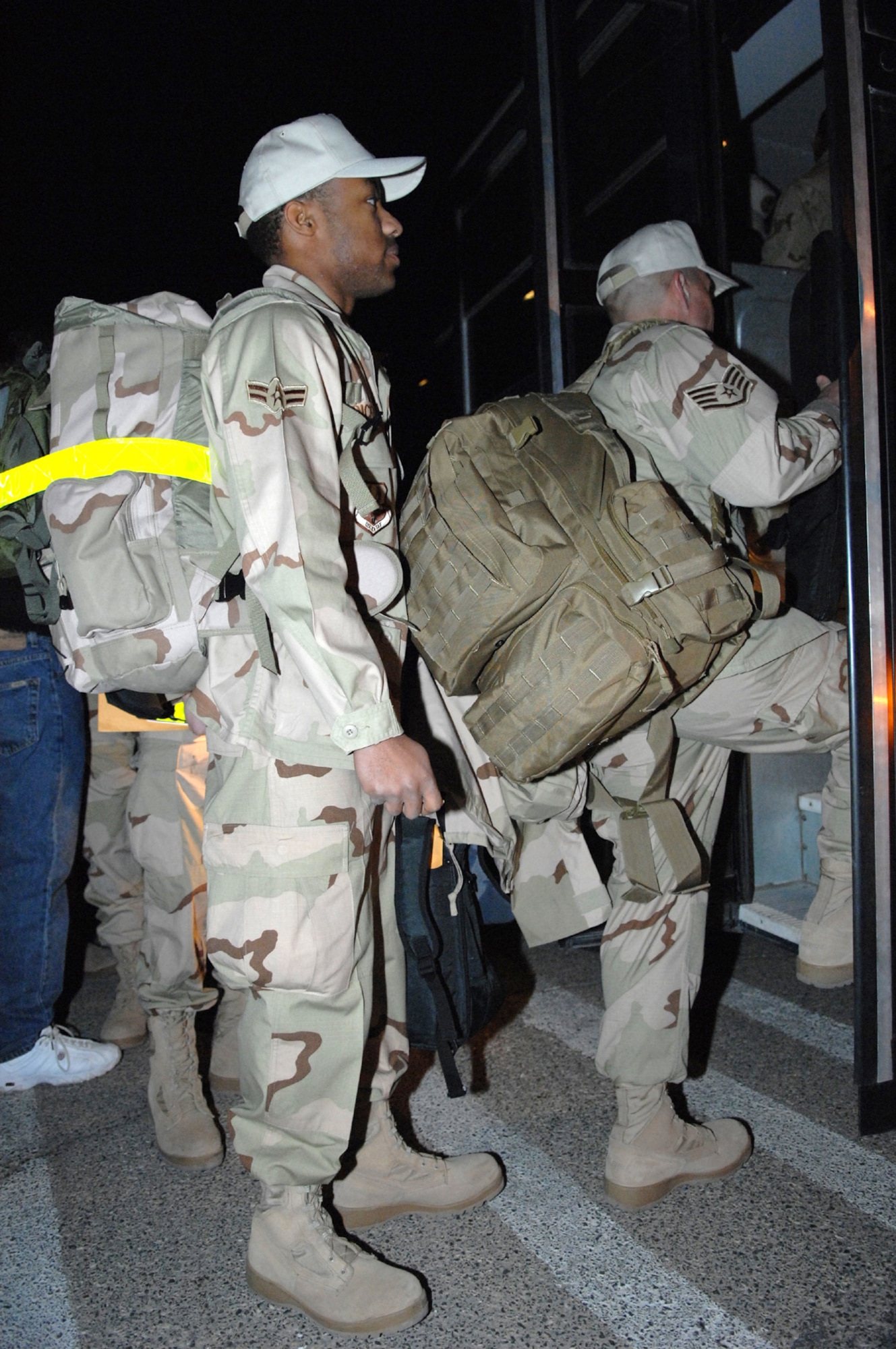 Members of the United States Air Force's 555th RED HORSE Squadron,  prepare to board a bus for their deployment March 30 in Support of Operations Iraqi and Enduring Freedom.
(U.S Air Force Photo/Senior Airman Larry E. Reid Jr.) 