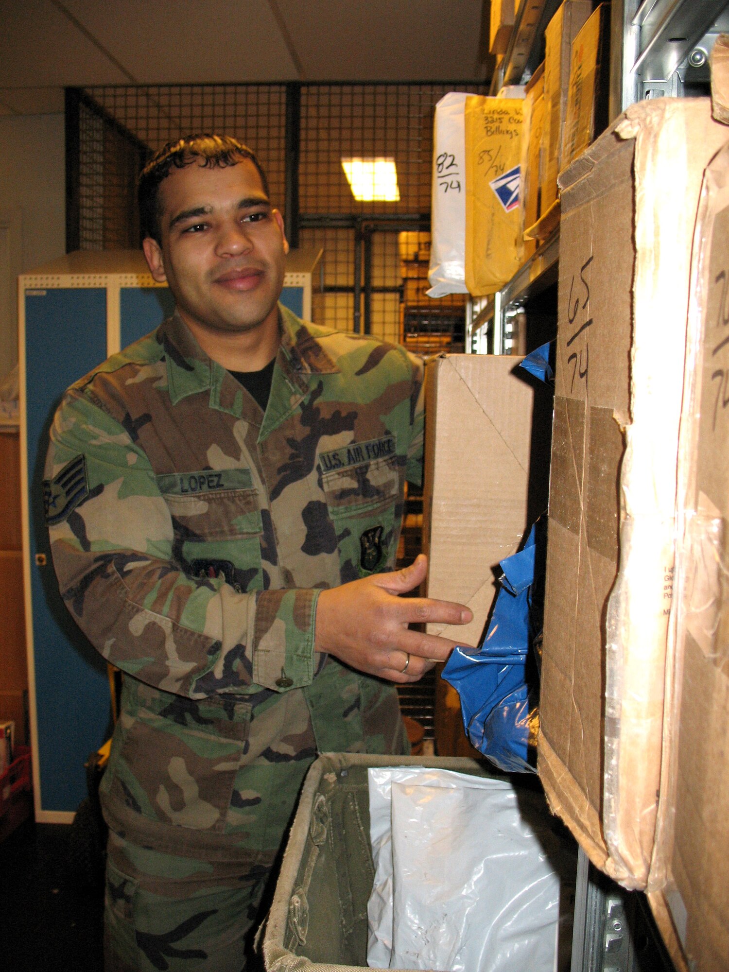 Staff Sgt. Tony Lopez stocks packages in the post office in March at Stavanger Air Base, Norway. Sergeant Lopez is the only Airman working in the post office supporting U.S. forces, civilians, and some NATO allies who work in the Joint Warfare Center and the 426th Air Base Squadron. Since most jobs in the squadron are only one-deep positions, other people help Sergeant Lopez with the mail. (U.S. Air Force photo/Staff Sgt. Laura Holzer) 
