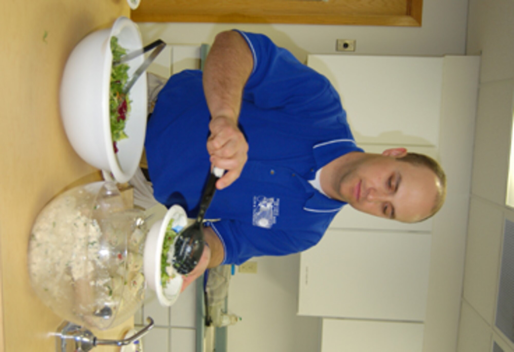 Dustin Frize, the new dietitian at the Health and Wellness Center, prepares a healthy crab salad, part of the seafood menu at the healthy cooking demonstration at the HAWC March 29. The cooking demonstration is held quarterly. The next menu is picnic at the beach. (U.S. Air Force photo/ Airman 1st Class Ashley Coomes)