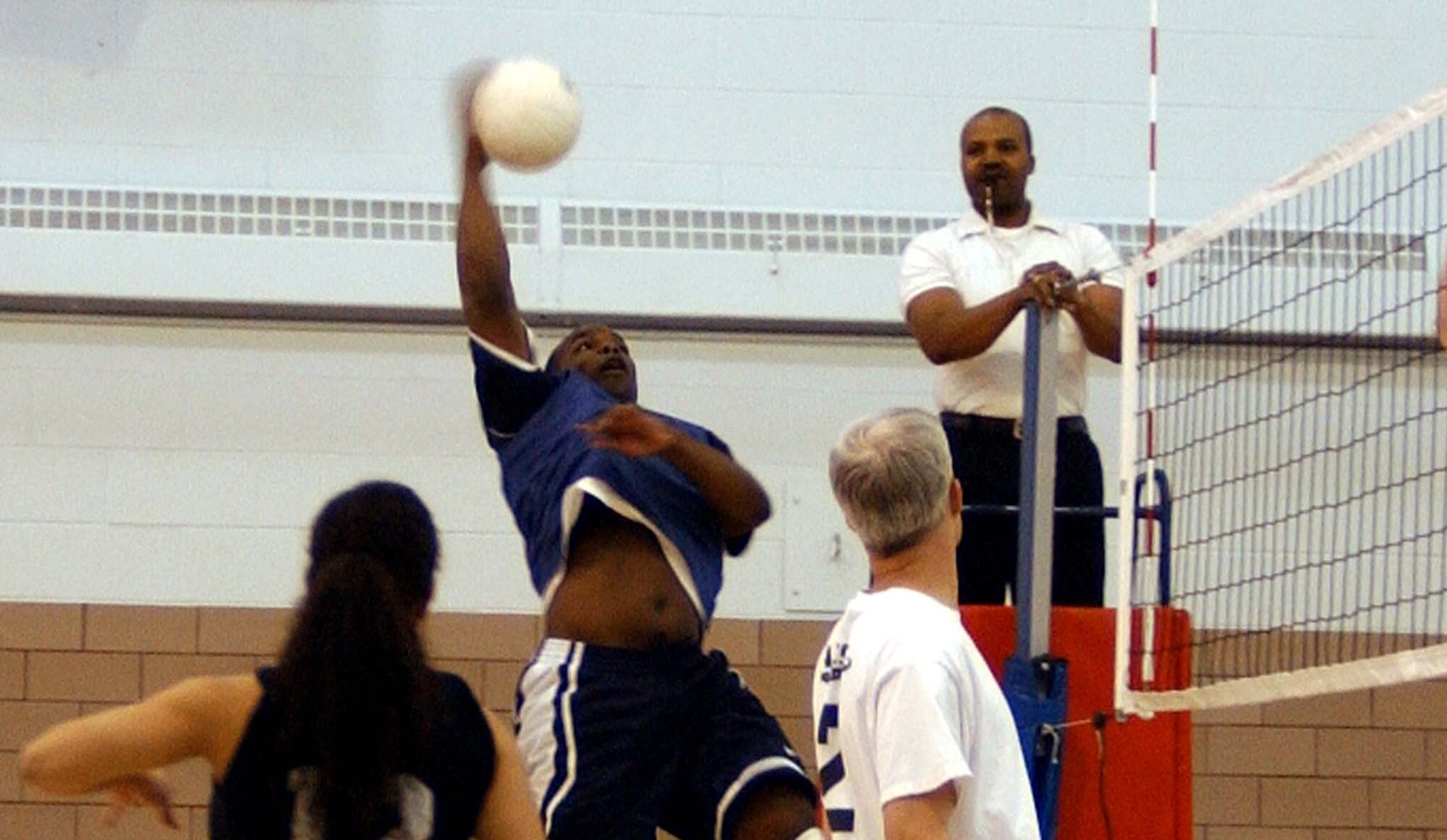 Kevin Campbell, 319th Logistics Readiness Squadron, spikes the ball to the 319th Operations Support Squadron's volleyball team during an intermeral game here April 2. OSS won 25-23, 25-18. (U.S. Air Force photo/Staff Sgt. Amanda Callahan)