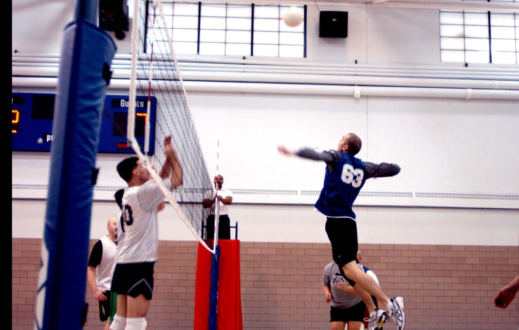 Casey Fielder, 319th Logistics Readiness Squadron, sets up to kill the ball into the 319th Operations Support Squadron. OSS won 25-23, 25-18; taking bragging rights from the previously undefeated LRS. (U.S. Air Force photo/Staff Sgt. Amanda Callahan)