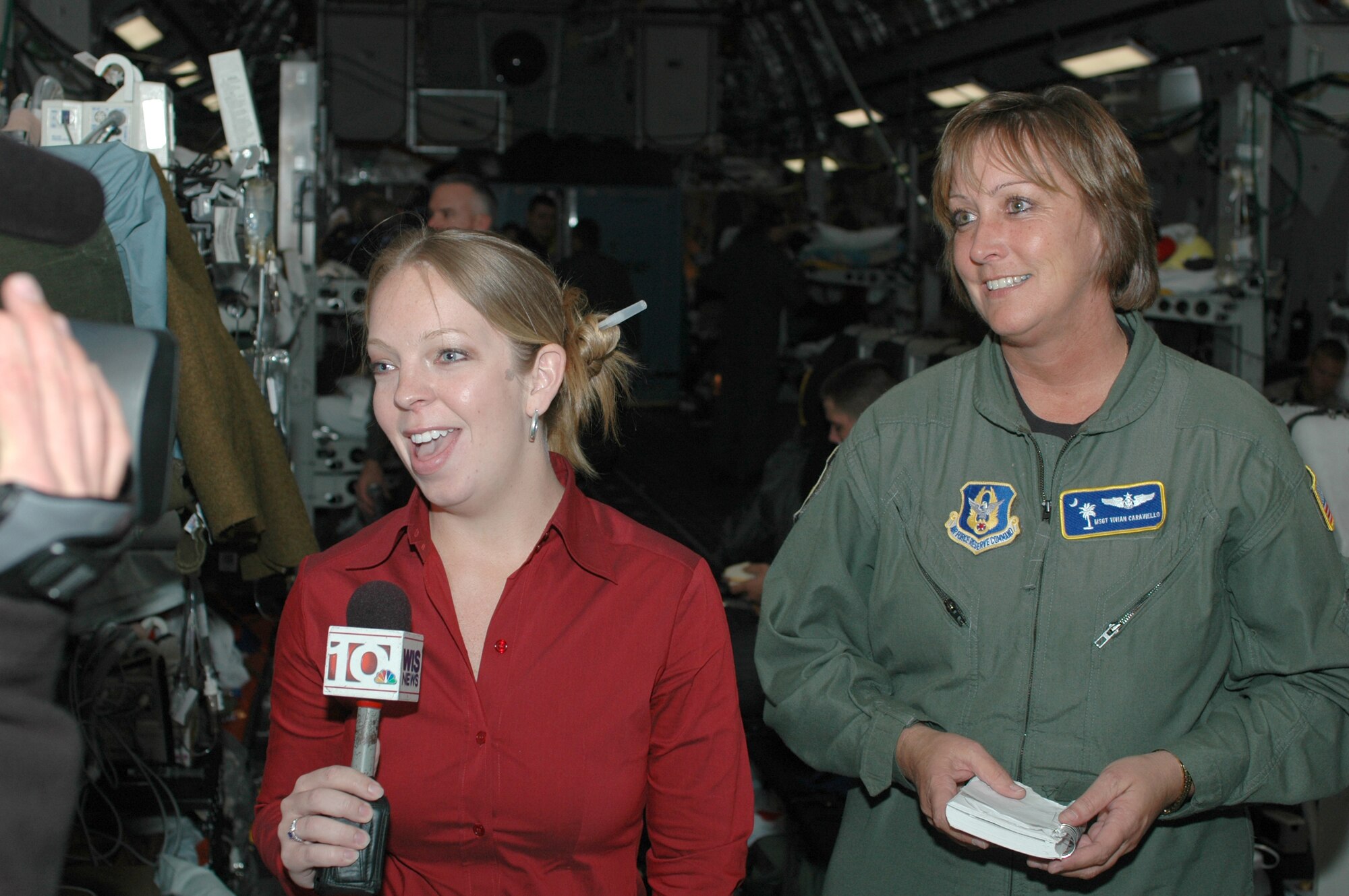 Stefanie Caraviello (left), the senior producer for WIS-TV in Columbia, S.C. interviews her mother, Master Sgt. Vivian Caraviello, a reservist with the 315th Aeromedical Evacuation Squadron at Charleston AFB, S.C.  Both Caraviello's were on a recent aeromedical evacuation mission; the mother caring for patients and the daughter telling the story.  (Photo by Capt. Wayne Capps, USAFR)