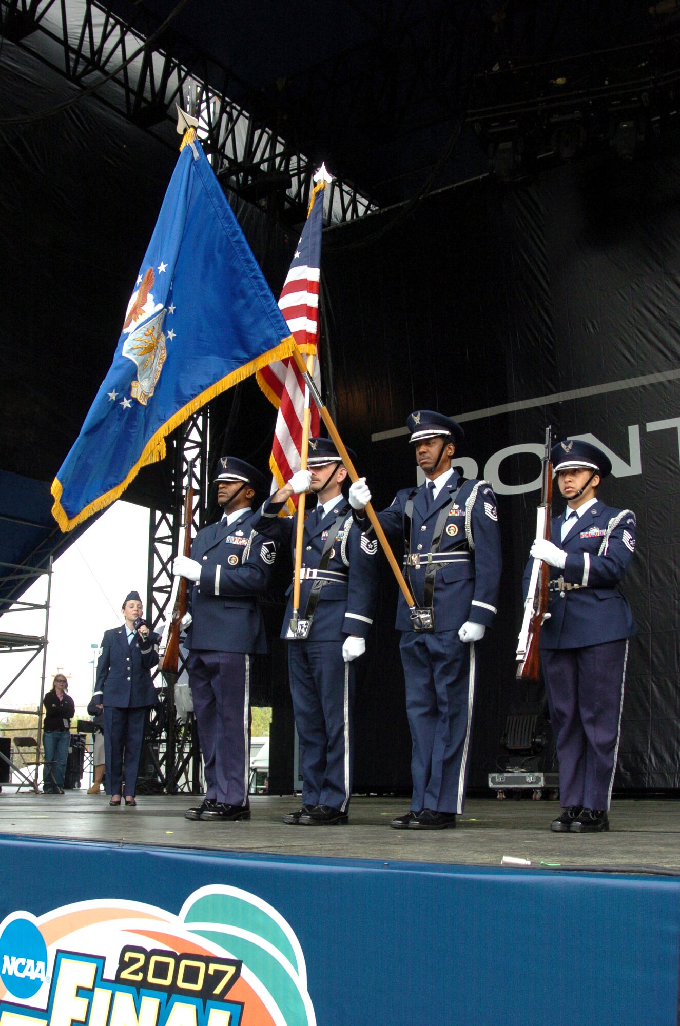 The 94th Airlift Wing Honor Guard present the colors during the singing of "The Star-Spangled Banner" by Tech. Sgt. Janis Thrift at the opening ceremony of the National Collegiate Athletic Association Final Four pep rally at Centennial Olympic Park March 31 in Atlanta. The honor guard was from Dobbins Air Reserve Base, Ga., and Sergeant Thrift is a vocalist from the Band of the U.S. Air Force Reserve at Robins Air Force Base, Ga. The NCAA featured the Air Force as part of its Final Four celebration to highlight the service of the men and women in uniform to the United States. (U.S. Air Force photo/Master Sgt. Stan Coleman) 
