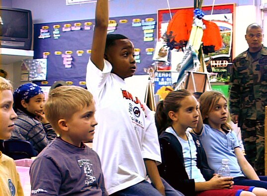 Elijah Wood, a 4th grade student at Yokota Air Base, Japan's West Elementary School, raises his hand March 30 to ask a fire fighter a question at the school's annual career day. The career day kicked off April being the "Month of the Military Child." (U.S. Air Force photo/Airman 1st Class Jessica Gilbert)