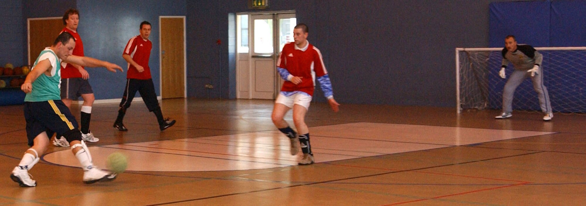William Gaytan, 100th Logistic Readiness Squardron (LRS) shoots on goal while 727th Air Mobility Squardron (AMS), Ash Point and goalie James Brown get ready to defend April 2, 2007 during the indoor soccer game. The 727th AMS defeated the 100th LRS-1 2 -1 at the Northside fitness center at RAF Mildenhall. (U.S. Air Force photo by Airman Brad Smith)