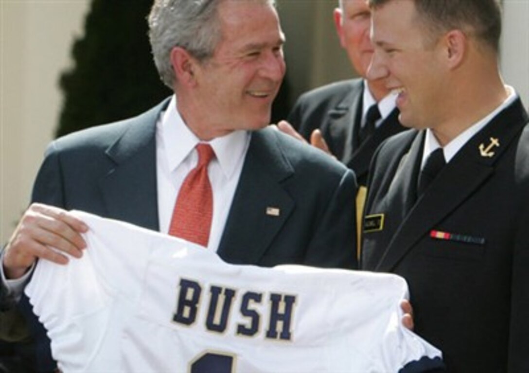 President George W. Bush accepts a jersey from co-captain Rob Caldwell of the U. S. Naval Academy football team in the Rose Garden at the White House, April 2, 2007. 
