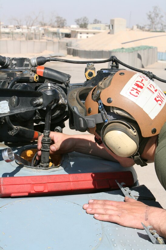 AL TAQADDUM, Iraq- Lance Corporal Kyle D. Witkowski, a CH-46E helicopter mechanic with Marine Medium Helicopter Squadron 161, adjusts the pitch of a rotor blade ensuring all three blades are on the same plane, April 5.