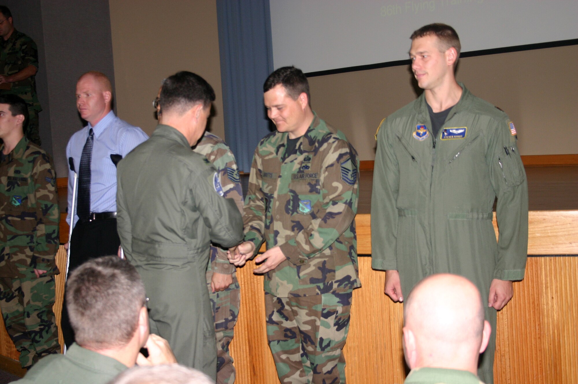 Master Sgt. David Drotts, 4th Force Support Squadron, receives an IG coin from Col. Joseph Barron, Air Education and Training Command Inspector General, during Laughlin Operational Readiness Inspection out brief Tuesday as other coin recipients stand at attention and look on.Other recipients of IG coins included Master Sgt. David Drotts, 47th Force Support Squadron; Bill Goins, 47th Aeromedical-Dental Squadron; Tech. Sgt. Alan Garcia, 47th Maintenance Directorate and Maj. Steve Kohut, 86th Flying Training Squadron.  (U.S. Air Force photo by Senior Airman Olufemi Owolabi)