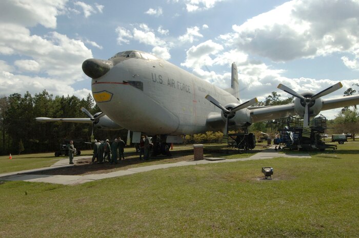 Members of Team Charleston clean up paint chips they removed from "Ol' Shakey," at the end of the duty day April 2.(U.S. Air Force photo/Staff Sgt. April Quintanilla)