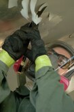 Senior Airman Randall Pearce, 315th Maintence Squadron Charleston AFB, S.C. begins the restoration process of Ol' Shakey by scraping off the old paint Monday, April 2.(U.S. Air Force photo/Staff Sgt. April Quintanilla)