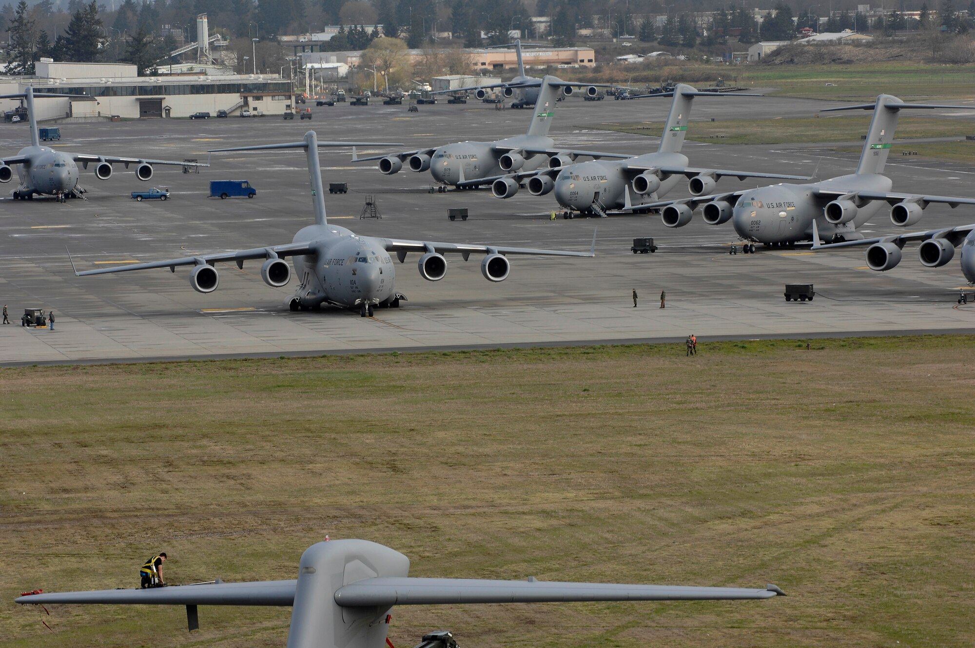 Airman 1st Class Bryan Walters kneels on the tail of a C-17 Globemaster III March 28 at McChord Air Force Base, Wash., and prepares to replace an integrated flight control module on the aircraft. Airman Walters is assigned to the 62nd Aircraft Maintenance Squadron.  (U.S. Air Force photo/Abner Guzman) 
