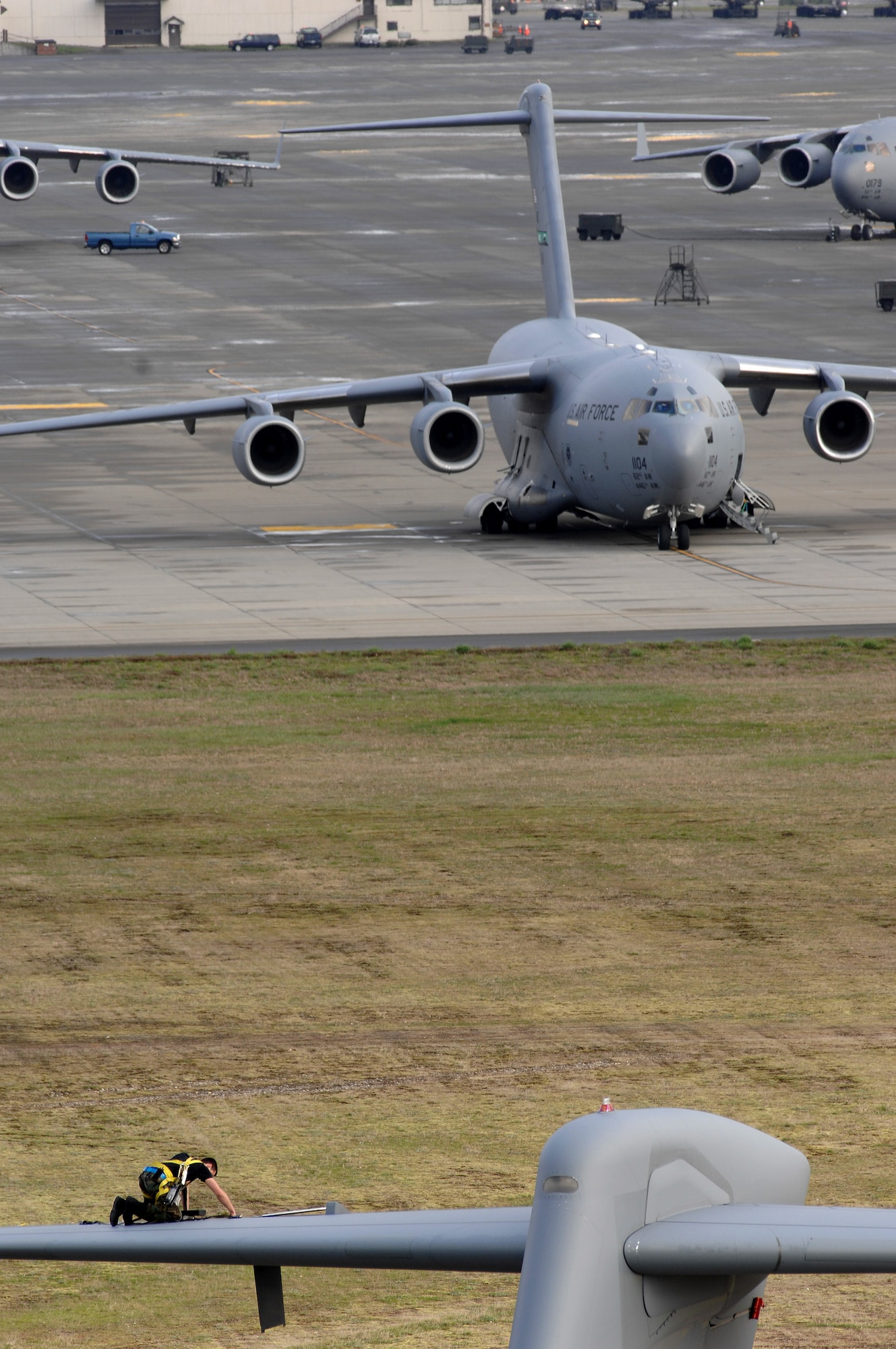 Airman 1st Class Bryan Walters kneels on the tail of a C-17 Globemaster III March 28 at McChord Air Force Base, Wash., and prepares to replace an integrated flight control module on the aircraft. Airman Walters is assigned to the 62nd Aircraft Maintenance Squadron.  (U.S. Air Force photo/Abner Guzman) 