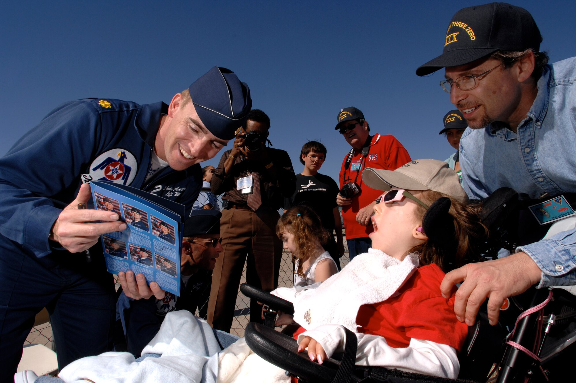 Thunderbird pilot Maj. Chris Austin visits with special needs and "Make a Wish" guests after a Thunderbird practice show March 30 at Naval Base Ventura County, Point Mugu, Calif.  (U.S. Air Force photo/Tech. Sgt. Justin D. Pyle)