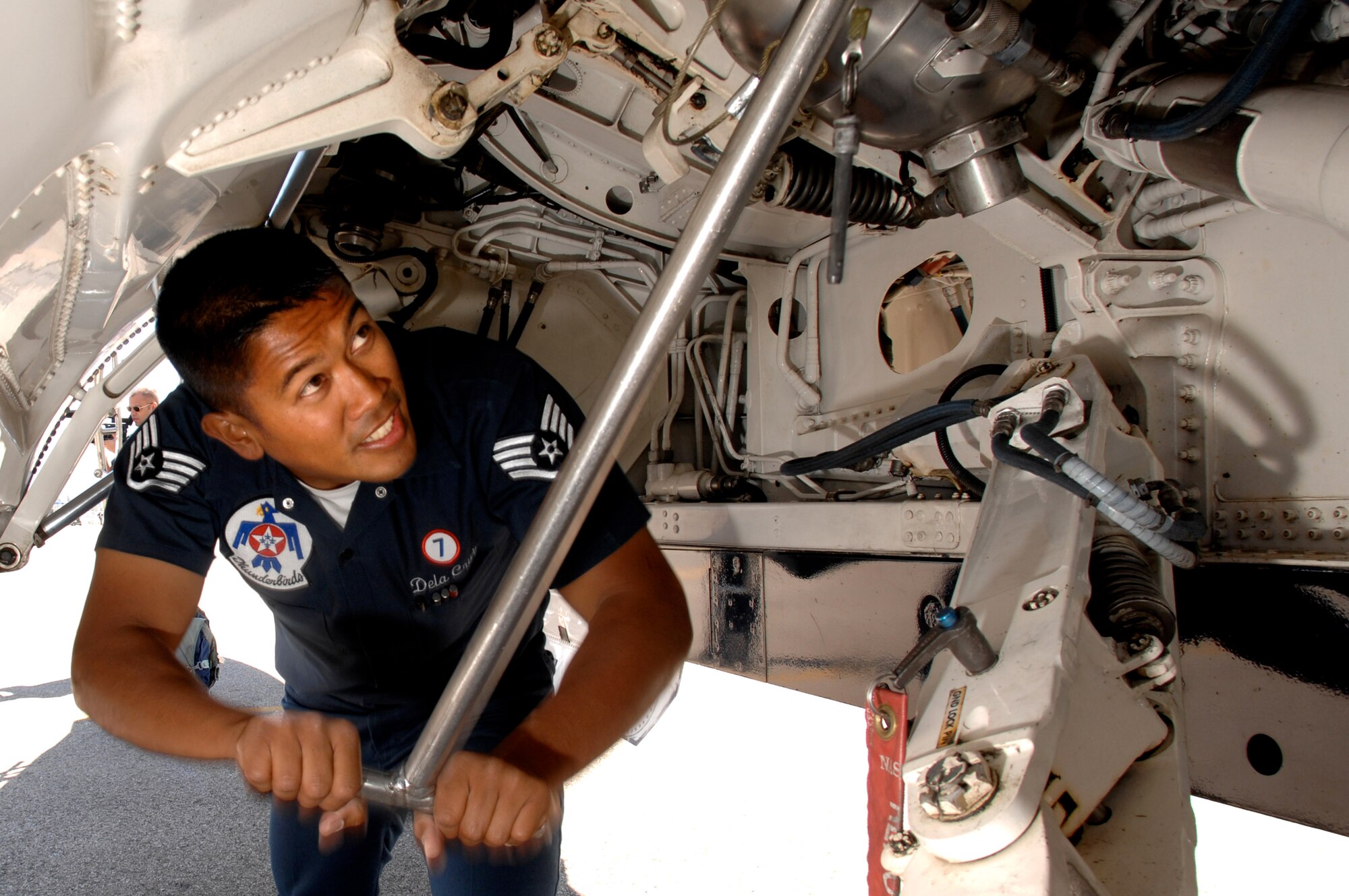 Staff Sgt. Greg Dela Cruz, a crew chief with the Air Force Thunderbirds, services the fuel starter on one of the jets March 30 prior to a Thunderbird practice show at Naval Base Ventura County, Point Mugu, Calif.  (U.S. Air Force photo/Tech. Sgt. Justin D. Pyle) 