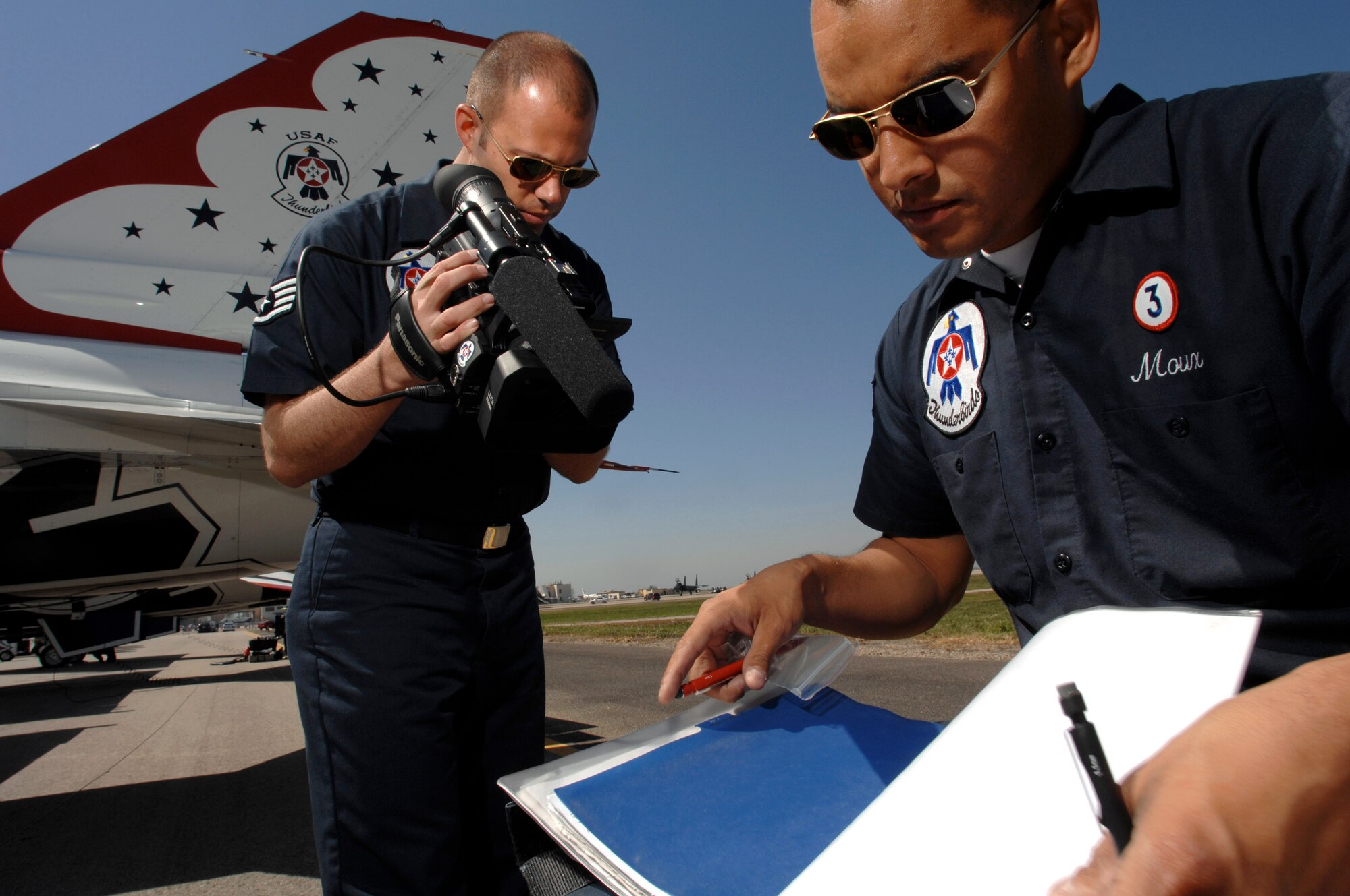 Staff Sgt. Josh Gray, a broadcaster with the Air Force Thunderbirds, videotapes crew chief Staff Sgt. Noel Moux March 30 prior to a Thunderbird practice show at Naval Base Ventura County, Point Mugu, Calif.  (U.S. Air Force photo/Tech. Sgt. Justin D. Pyle)