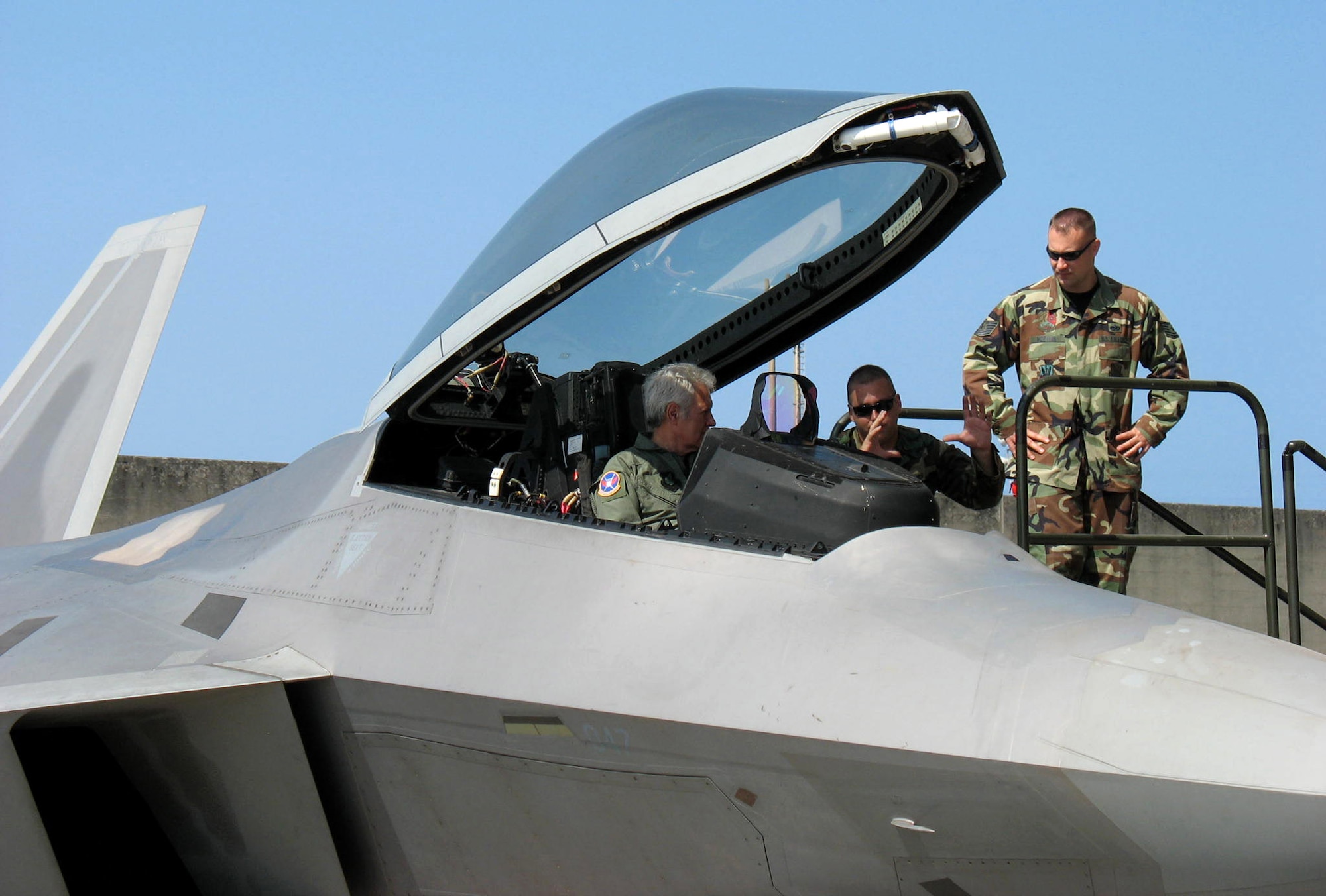 Alex Trebek sits in an F-22 Raptor as Staff Sgt. Michael Mauriello and Tech. Sgt. Chris McEwan explain the instruments in the cockpit during a "Jeopardy" USO tour to Japan March 31 at Kadena Air Base, Japan. During the "Jeopardy" show's two-day trip to Kadena AB, Mr. Trebek and show staff also toured a KC-135 Stratotanker, an E-3 Sentry, F-15 Eagle, and an HH-60 Pave Hawk. Sergeants Mauriello and McEwan are both deployed here from the 27th Fighter Squadron at Langley Air Force Base, Va. Kadena AB residents were allowed to try-out to be contestants on "Jeopardy." (U.S. Air Force photo/Senior Master Sgt. Kenneth Fidler)
