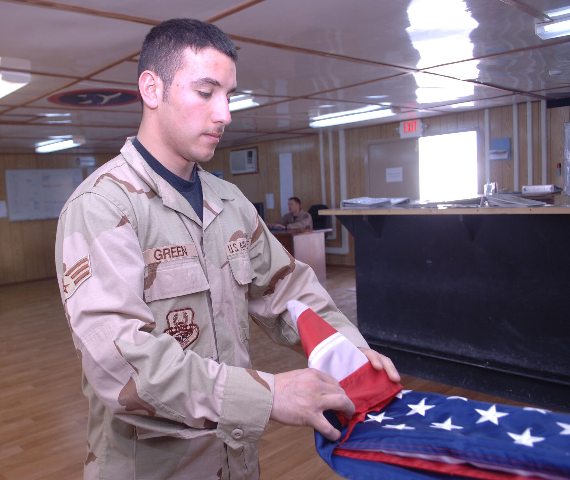 Senior Airman Ryan Green, an F-15E crew chief for the 455th Expeditionary Aircraft Maintenance Squadron, makes sure each and every American flag is properly folded once it is returned from flying aboard 455th Air Expeditionary Wing aircraft on a combat mission. (U.S. Air Force photo/Staff Sgt. Kevin Tomko)