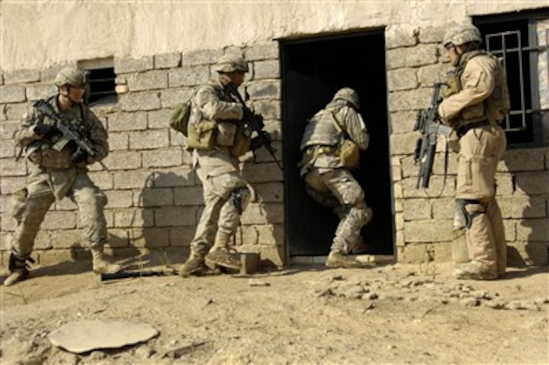 U.S. Army soldiers breach a house to search for insurgent activities during an operation in Zaghiniyat, Iraq, on March 29, 2007.  Soldiers from Charlie Troop, 5th Squadron, 73rd Cavalry Regiment, 82nd Airborne Division, Fort Bragg, N.C., are on a mission to rid the area of insurgent forces and to allow coalition forces freedom of movement throughout the area.  