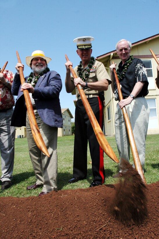 Neil Abercrombie and Brig. Gen. Steven A. Hummer use an Oo stick to commemorate the groundbreaking ceremony of the beginning of phase one of the Public-Private Venture, April 4.