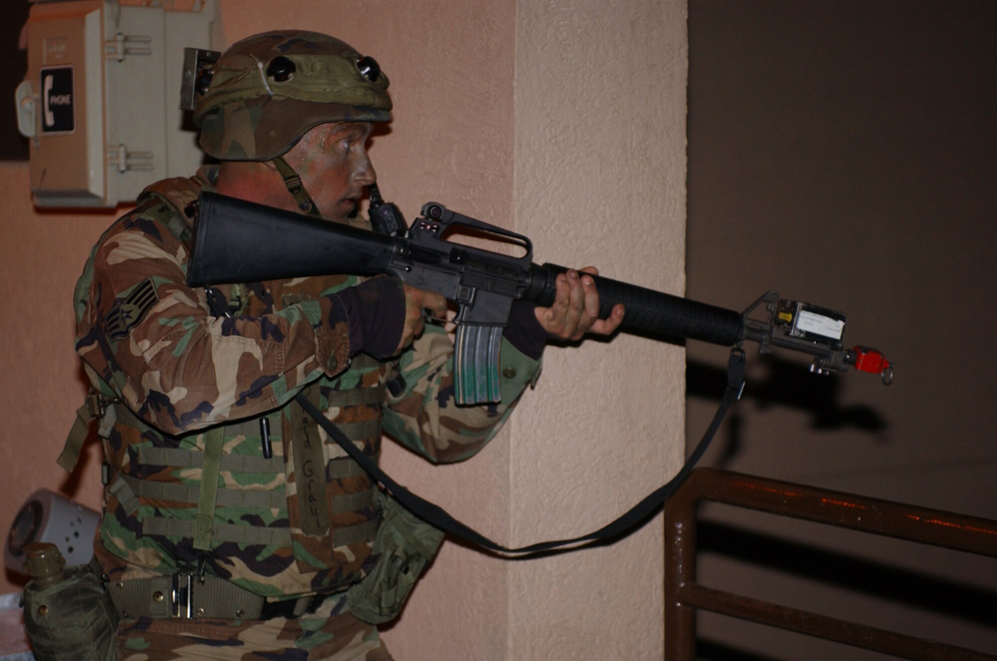 OSAN AIR BASE, Republic of Korea --  Staff Sgt. Donald Gray, 51st Communications Squadron, prepares to take on opposing forces during a recent 51st CS Installation Arming and Response/Selective Armament team exercise here. The team is meant to protect the communications building in case of an attack. (U.S. Air Force photo by Airman 1st Class Chad Strohmeyer)