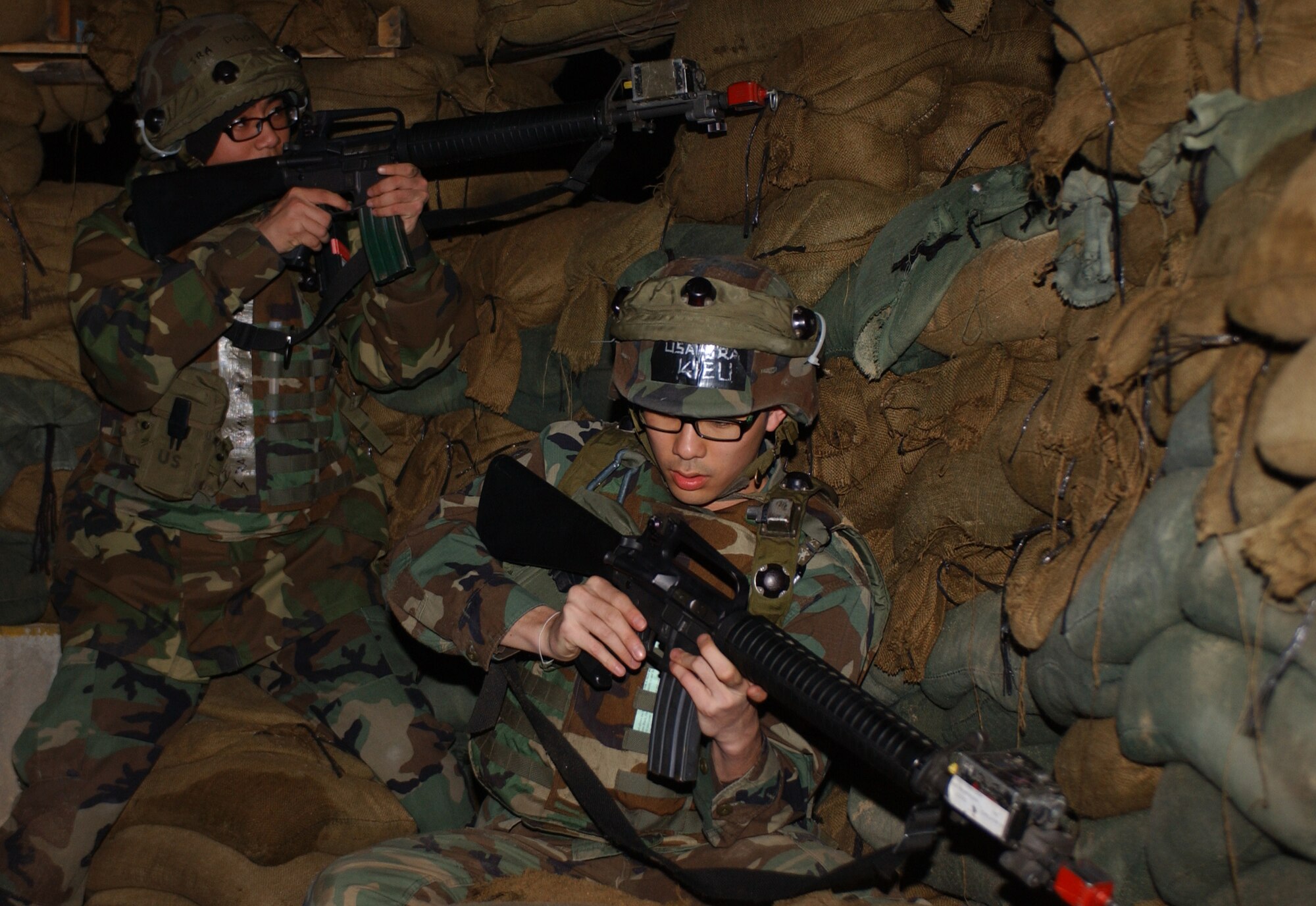 OSAN AIR BASE, Republic of Korea --  Senior Airman Thuy Kieu (right) and Airman 1st Class Luca Phan, 51st Communications Squadron, prepare to take on opposing forces during a recent 51st CS IAR/SELARM team exercise here. The team is meant to protect the communications building in case of an attack. (U.S. Air Force photo by Airman 1st Class Chad Strohmeyer)