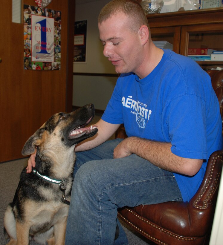 Puddles looks up to his master before a drill weekend.  Photo/TSgt. Dan Oliver