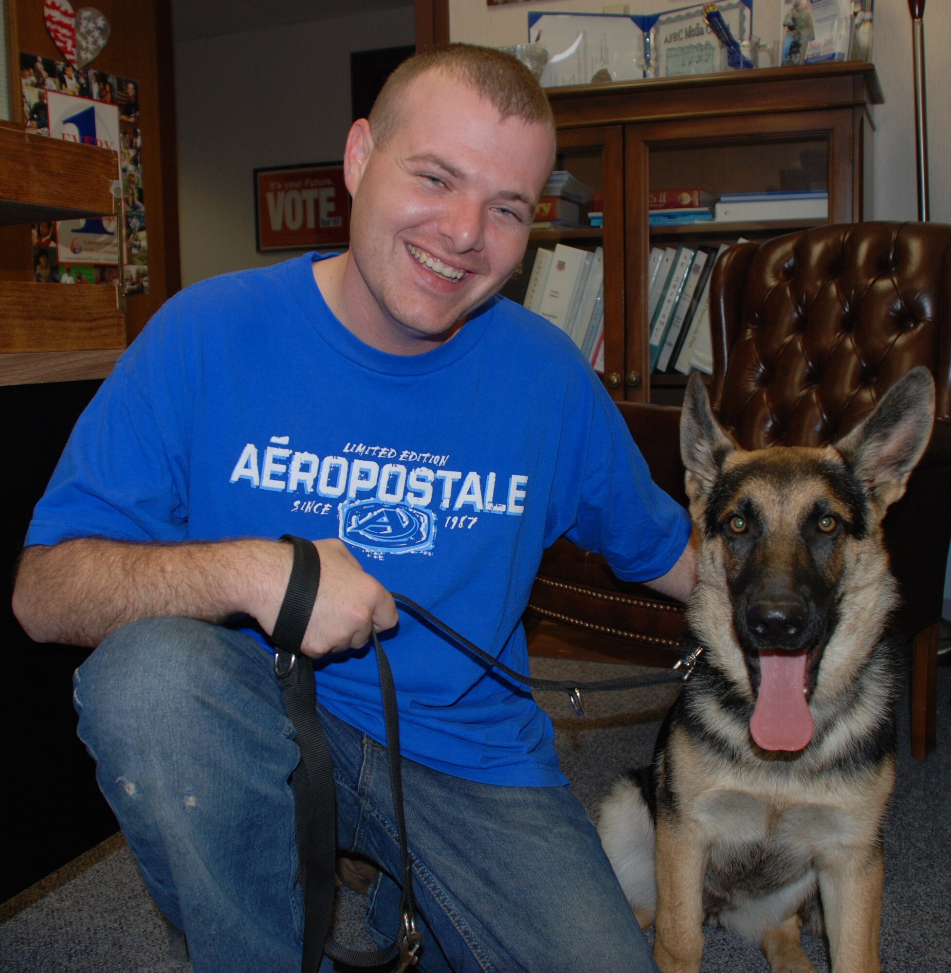 Airman Tyler McGowan and his best friend Puddles stop in to the command section before a recent training assembly.  Airman McGowan is a member of the wing honor guard and the Aeromedical Evacuation Squadron.  Photo/TSgt. Dan Oliver