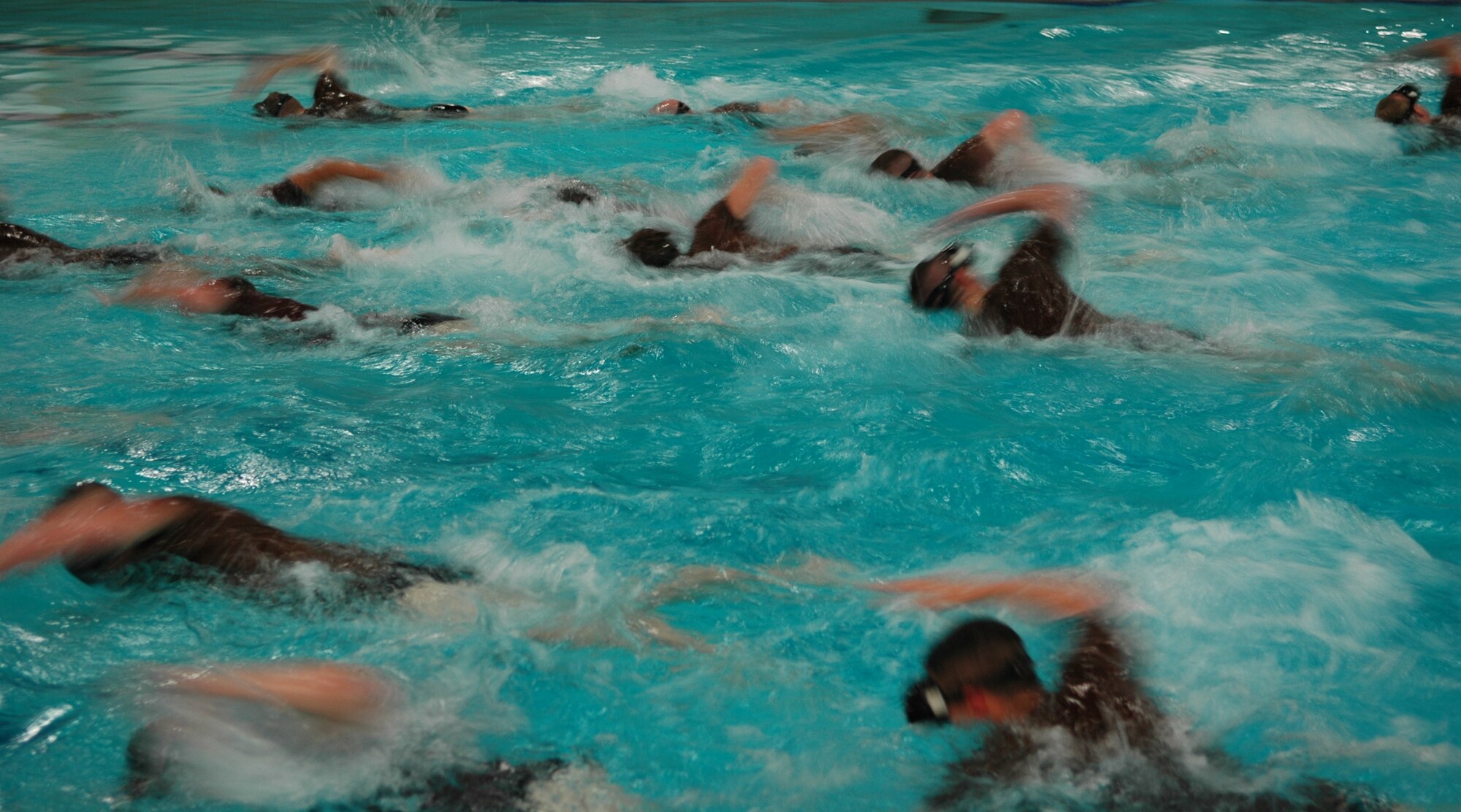 FAIRCHILD AIR FORCE BASE, Wash. -- Students from the phase two selection process swim from one side of the pool to the other. Once the instructors give a command to get ready for the next exercise, the trainees are given less than 30 seconds to get there and prepare themselves. Through the week-long course, 43 percent of the students that arrive will be release from the class for various reasons. (U.S. Air Force photo/Staff Sgt. Larry Carpenter)