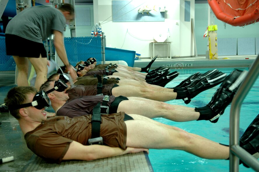 FAIRCHILD AIR FORCE BASE, Wash. -- Phase two candidates perform flutter kicks while wearing their masks and fins. An instructor walks the line filling the trainees’ masks with water. Trainees undergo an entire week of exercises that will test them both physically and mentally. (U.S. Air Force photo/Staff Sgt. Larry Carpenter)