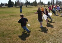 FAIRCHILD AIR FORCE BASE, Wash. -- Children, ages six to eight take off in a flash to start gathering Easter eggs that were spread across the field next to the tennis courts here April 1. The Easter egg hunt was just one of the activities scheduled for the children, the others included games, face painting, raffle drawings for prizes and a fire truck inflatable bounce toy from the base fire department. The event was attended by more than 200 people. (U.S. Air Force photo/Corrine Brown)