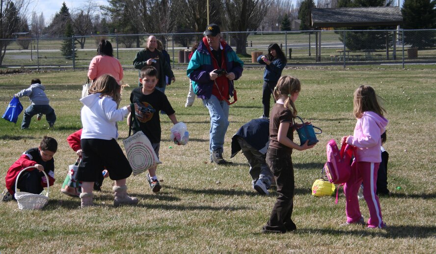 FAIRCHILD AIR FORCE BASE, Wash. -- The scramble is on as children scour the ground for the Easter eggs scattered around the field next to the tennis courts here April 1. Parents stand around with their cameras loaded and fingers on the trigger just waiting for the perfect shot of the children in action. All of the children that didn’t have a basket were given bags to collect their Easter eggs. (U.S. Air Force photo/Corrine Brown)